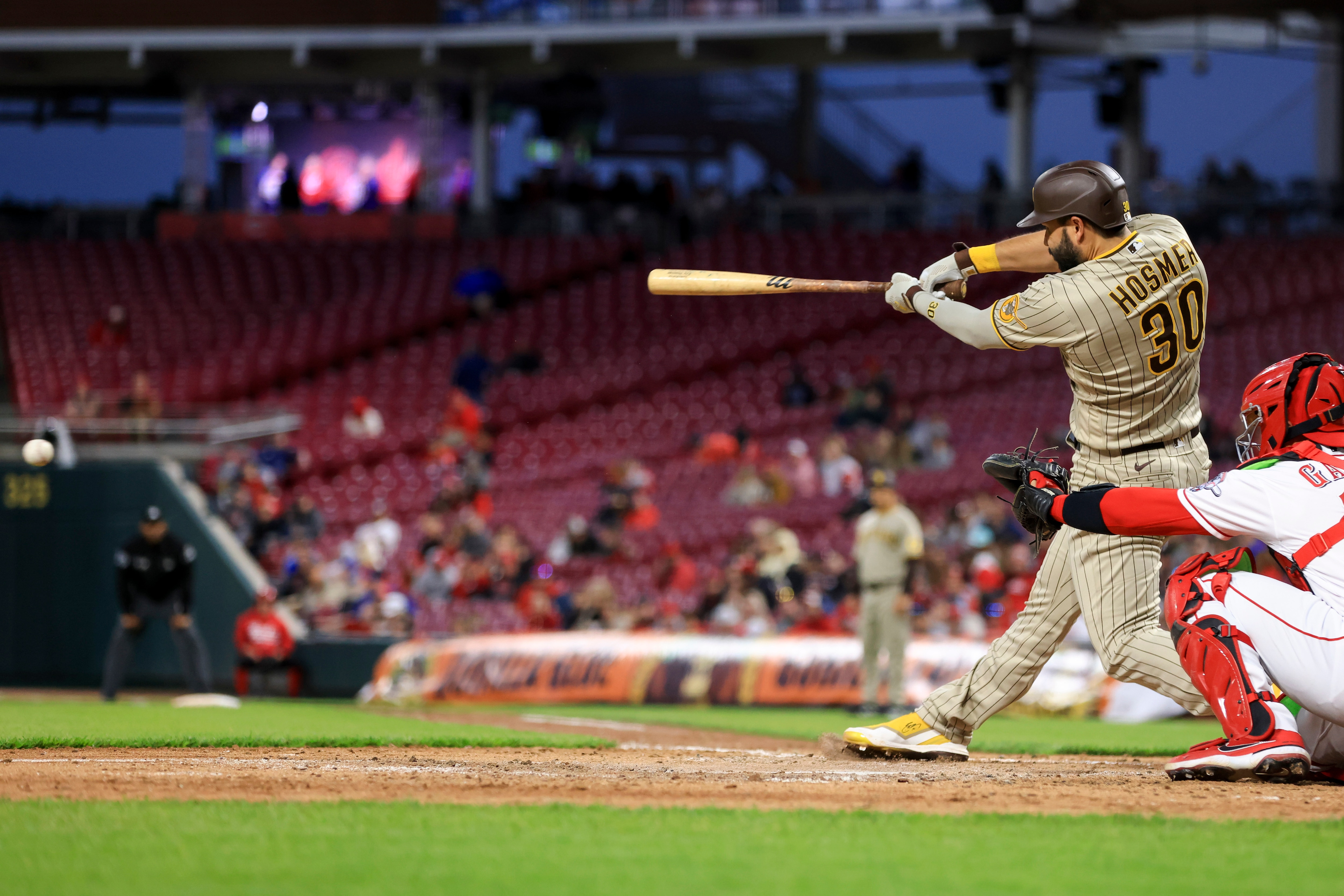 San Diego Padres' Eric Hosmer hits an RBI single during the fifth inning of a baseball game against the Cincinnati Reds in Cincinnati, Wednesday, April 27, 2022. (AP Photo/Aaron Doster)