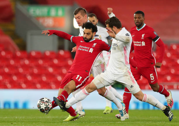 Liverpool's Mohamed Salah (left) and Real Madrid's Fernandez Nacho battle for the ball during the UEFA Champions League match at Anfield, Liverpool. Picture date: Wednesday April 14, 2021. See PA story SOCCER Liverpool. Photo credit should read: Peter Byrne/PA Wire. RESTRICTIONS: Editorial use only, no commercial use without prior consent from rights holder. (Photo by Peter Byrne/PA Images via Getty Images)