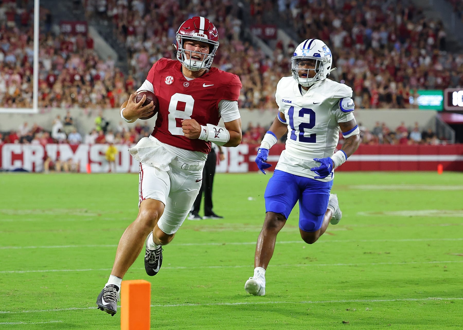 TUSCALOOSA, ALABAMA - SEPTEMBER 02:  Tyler Buchner #8 of the Alabama Crimson Tide rushes for a touchdown against Jalen Davis #12 of the Middle Tennessee Blue Raiders during the fourth quarter at Bryant-Denny Stadium on September 02, 2023 in Tuscaloosa, Alabama. (Photo by Kevin C. Cox/Getty Images)