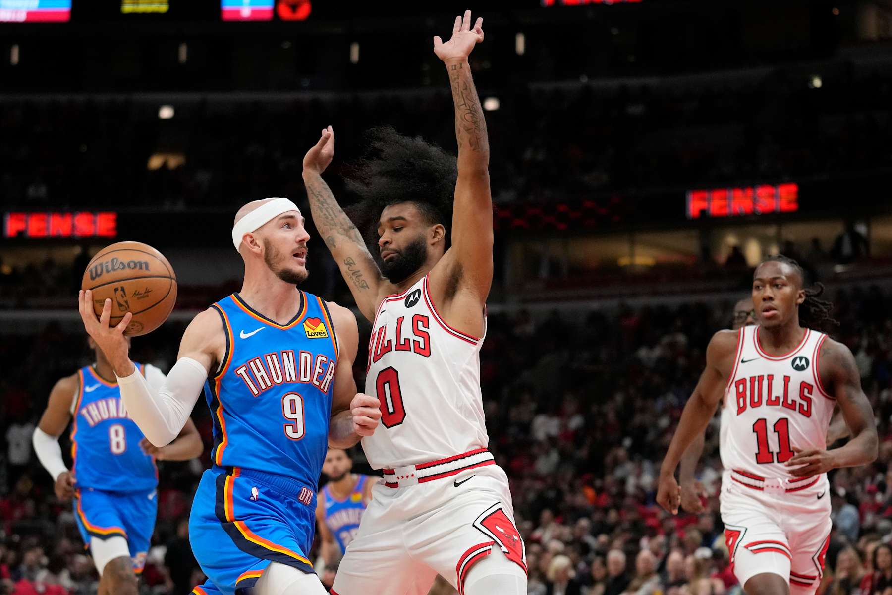 CHICAGO, ILLINOIS - OCTOBER 26: Alex Caruso #9 of the Oklahoma City Thunder dribbles the ball against Coby White #0 of the Chicago Bulls in the second quarter during a game at the United Center on October 26, 2024 in Chicago, Illinois. NOTE TO USER: User expressly acknowledges and agrees that, by downloading and or using this photograph, User is consenting to the terms and conditions of the Getty Images License Agreement. (Photo by Patrick McDermott/Getty Images)