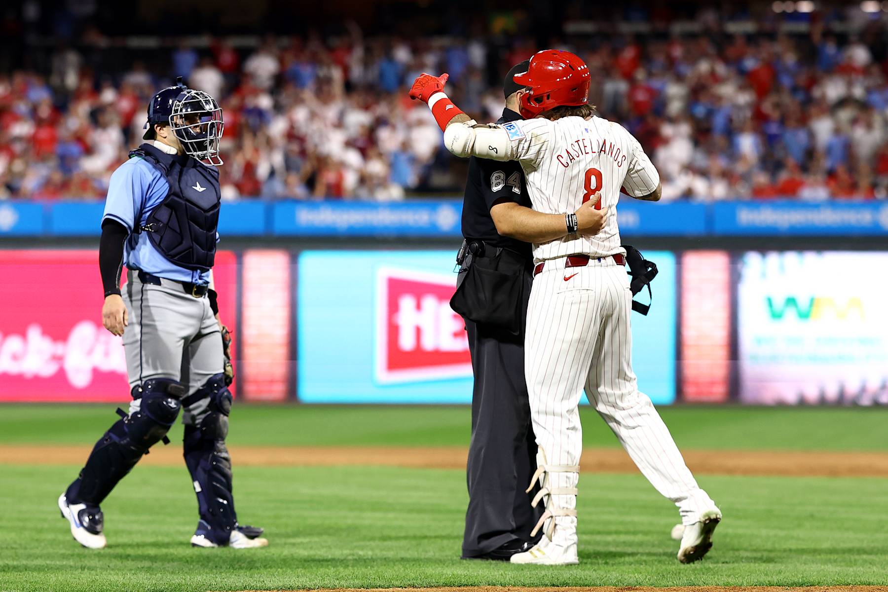 PHILADELPHIA, PENNSYLVANIA - SEPTEMBER 10: Nick Castellanos #8 of the Philadelphia Phillies reacts after being hit by a pitch during the eighth inning against the Tampa Bay Rays at Citizens Bank Park on September 10, 2024 in Philadelphia, Pennsylvania. (Photo by Tim Nwachukwu/Getty Images)
