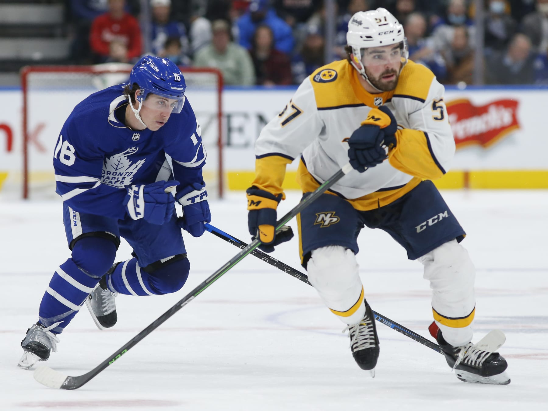 TORONTO, ON - NOVEMBER 16: Toronto Maple Leafs center Mitchell Marner (16) hustles up ice behind Nashville Predators defenseman Dante Fabbro (57). Toronto Maple Leafs vs Nashville Predators during 3rd period play NHL regular season action at Scotiabank Arena in Toronto. Leafs won 3-0. CORONOAPD. Toronto Star/Rick Madonik        (Rick Madonik/Toronto Star via Getty Images)