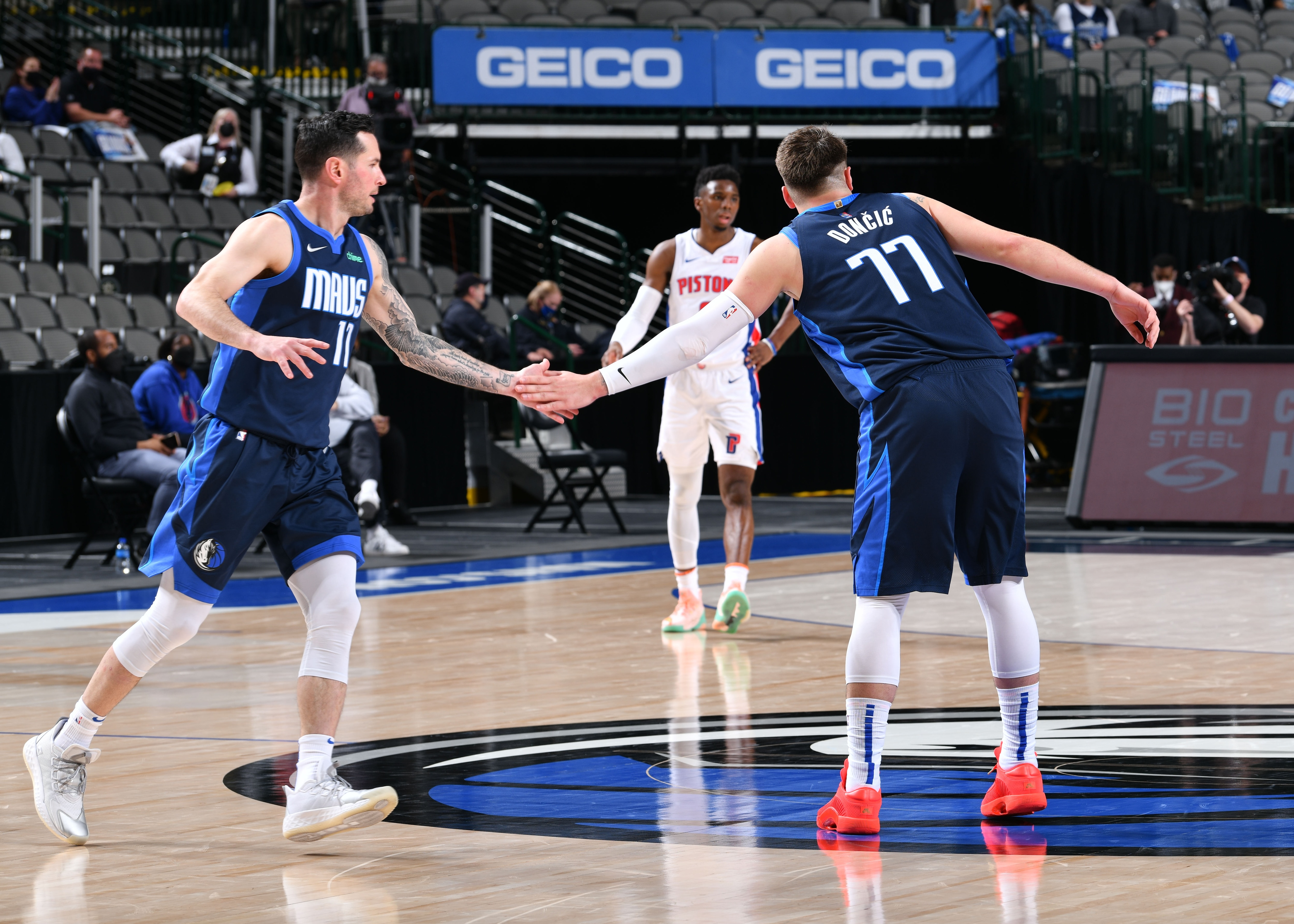 DALLAS, TX - APRIL 21: JJ Redick #17 hi-fives Luka Doncic #77 of the Dallas Mavericks during the game against the Detroit Pistons on April 21, 2021 at the American Airlines Center in Dallas, Texas. NOTE TO USER: User expressly acknowledges and agrees that, by downloading and or using this photograph, User is consenting to the terms and conditions of the Getty Images License Agreement. Mandatory Copyright Notice: Copyright 2021 NBAE (Photo by Glenn James/NBAE via Getty Images)