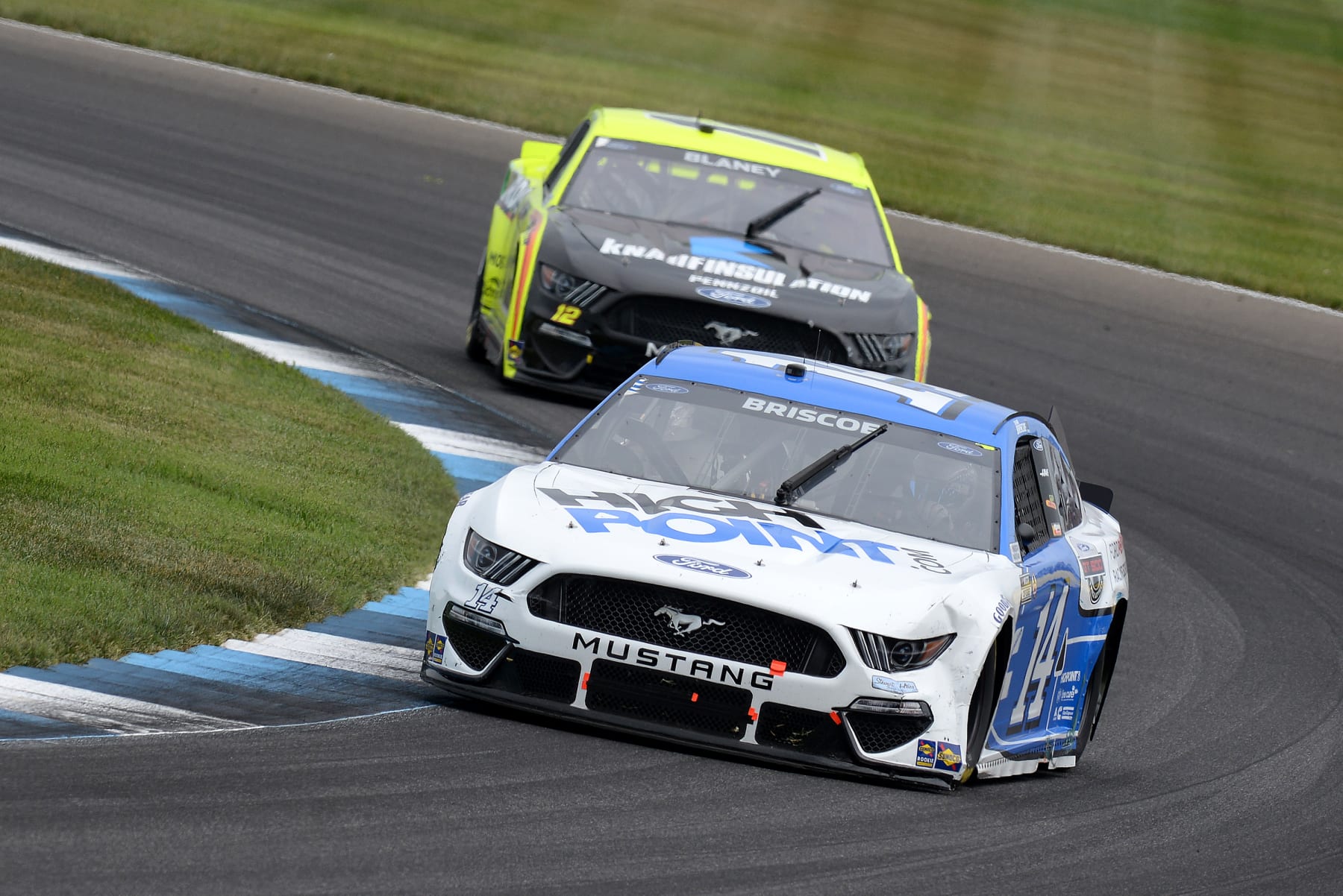 INDIANAPOLIS, IN - AUGUST 15: Chase Briscoe, #14 Stewart-Haas Racing, Ford Mustang HighPoint.com/Ford Performance Racing School drives through turn fourteen ahead of Ryan Blaney, #12 Team Penske, Ford Mustang Menards/Krauf during the NASCAR Cup Series Verizon 200 at the Brickyard on August 15, 2021, at the Indianapolis Motor Speedway Road Course in Speedway, Indiana. (Photo by Michael Allio/Icon Sportswire via Getty Images)