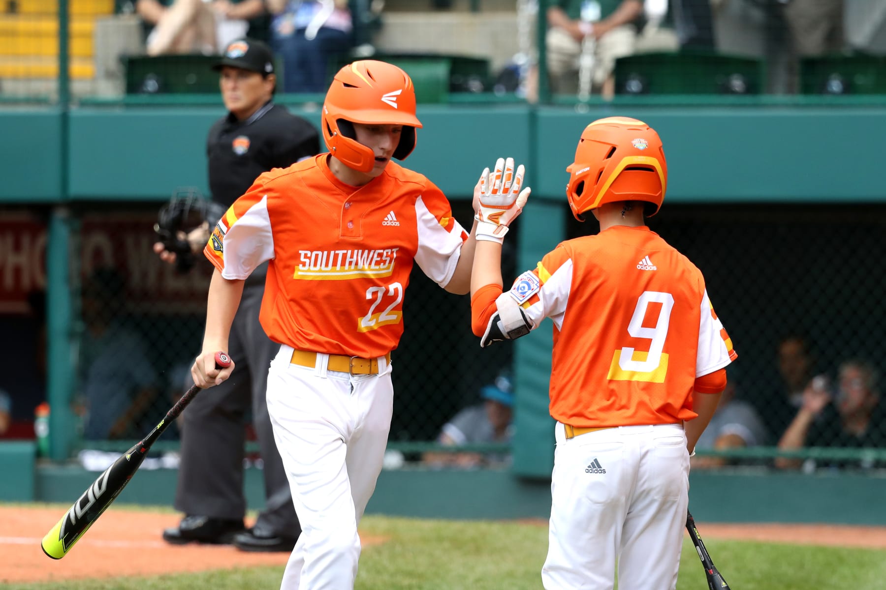 SOUTH WILLIAMSPORT, PENNSYLVANIA - AUGUST 25: Reece Roussel #22 of the Southwest Region team from River Ridge Louisiana celebrates scoring a run in the third inning with teammate Conner Perrot #9 agains the Caribbean Region team from Willemstad, Curacao in the first inning during the Championship Game of the Little League World Series at Lamade Stadium on August 25, 2019 in South Williamsport, Pennsylvania. (Photo by Rob Carr/Getty Images)