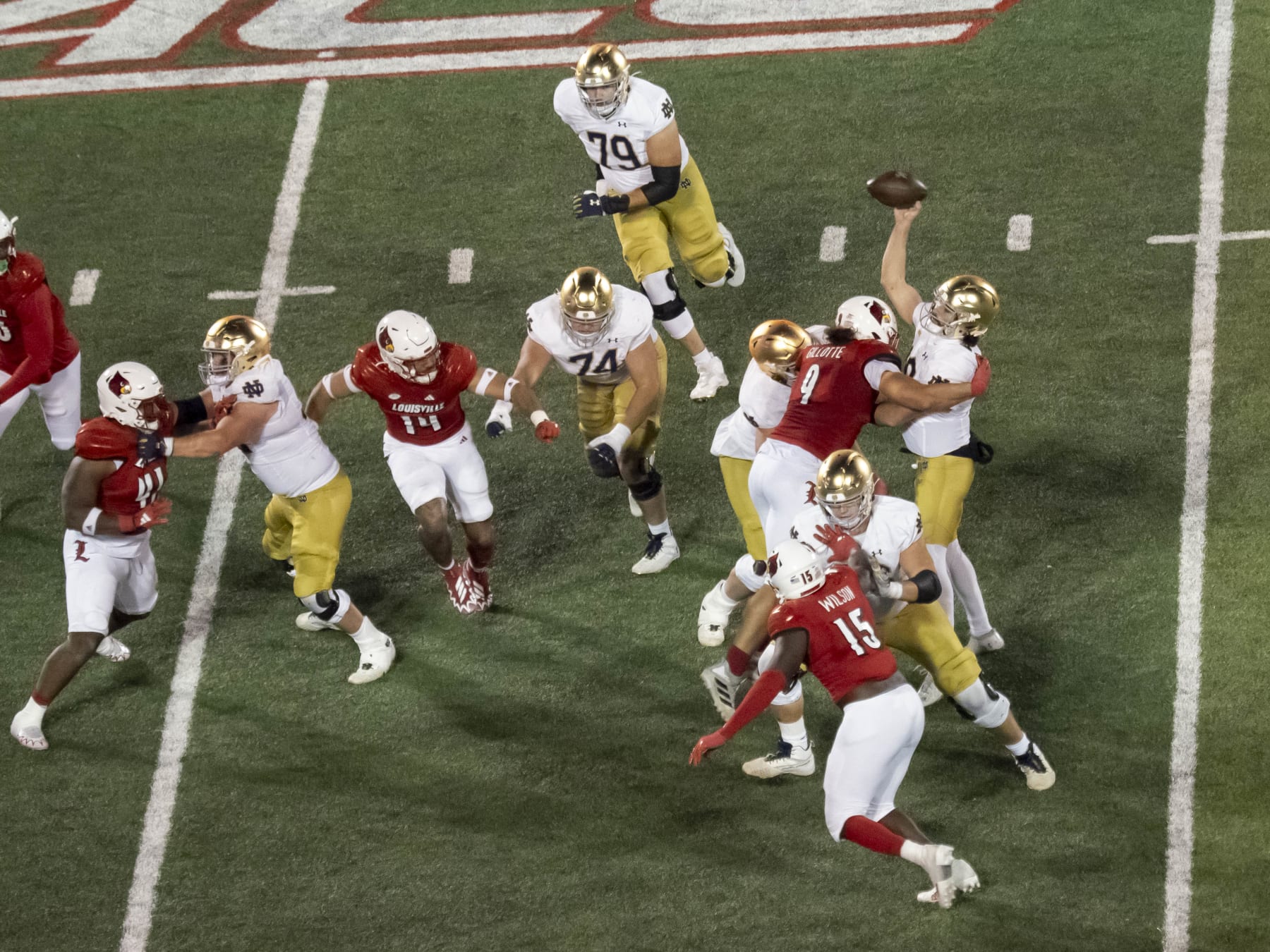 LOUISVILLE, KY - OCTOBER 07: Notre Dame Fighting Irish quarterback Sam Hartman (10) gets tackled by Louisville Cardinals defensive lineman Ashton Gillotte (9) during the college football game between the Notre Dame Fighting Irish and the Louisville Cardinals  on October 7, 2023, at L&N Federal Credit Union Stadium in Louisville, KY. (Photo by Joseph Weiser/Icon Sportswire via Getty Images)