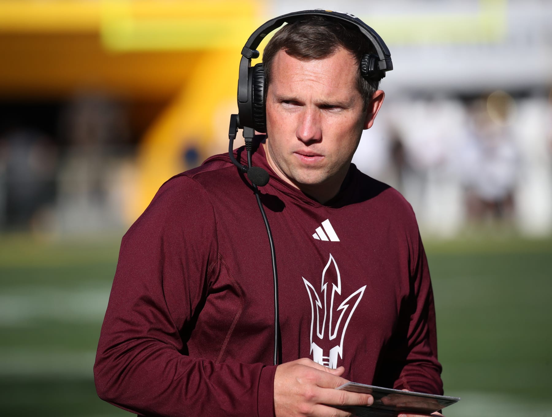 TEMPE, ARIZONA - NOVEMBER 25: Head Coach Kenny Dillingham of the Arizona State Sun Devils looks to the sidelines while talking on his headset during the University of Arizona Wildcats versus the Arizona State Sun Devils football game at Mountain America Stadium on November 25, 2023 in Tempe, Arizona. (Photo by Bruce Yeung/Getty Images)