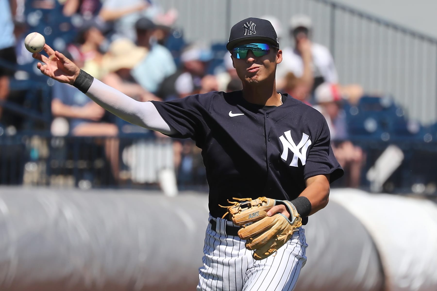TAMPA, FL - MARCH 24: New York Yankees Infielder Anthony Volpe (77) throws the ball over to first base during the spring training game between the Minnesota Twins and the New York Yankees on March 24, 2023 at George M. Steinbrenner Field in Tampa, FL. (Photo by Cliff Welch/Icon Sportswire via Getty Images)