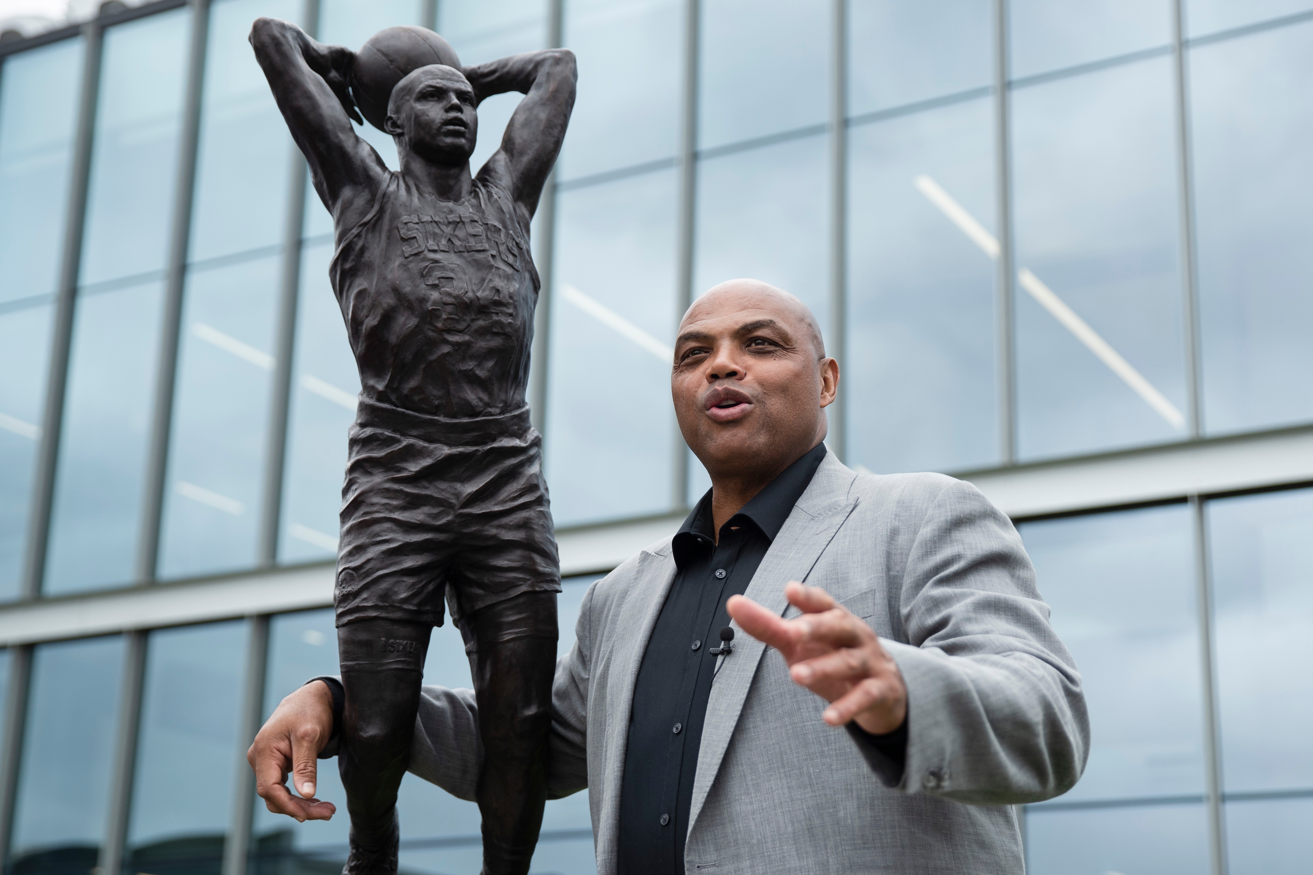 Charles Barkley poses for photographs with a sculpture honoring him at the Philadelphia 76ers NBA basketball training facility in Camden, N.J., Friday, Sept. 13, 2019. Barkley spent the first eight seasons of his storied career with Philadelphia after the 76ers chose him with the No. 5 overall pick in the 1984 NBA Draft. (AP Photo/Matt Rourke)