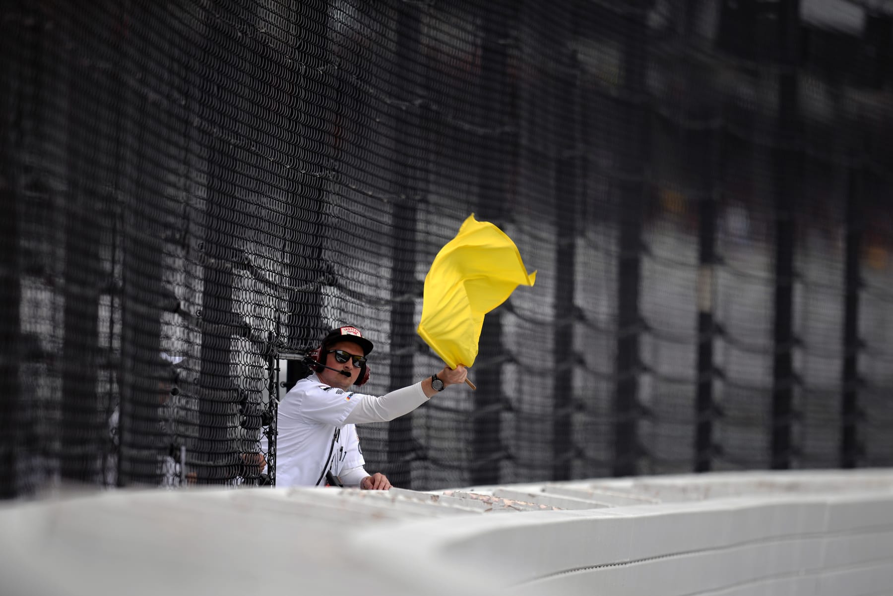 INDIANAPOLIS, IN - AUGUST 15: A corner worker displays a yellow flag during the NASCAR Cup Series Verizon 200 at the Brickyard on August 15, 2021, at the Indianapolis Motor Speedway in Speedway Indiana. (Photo by Michael Allio/Icon Sportswire via Getty Images)