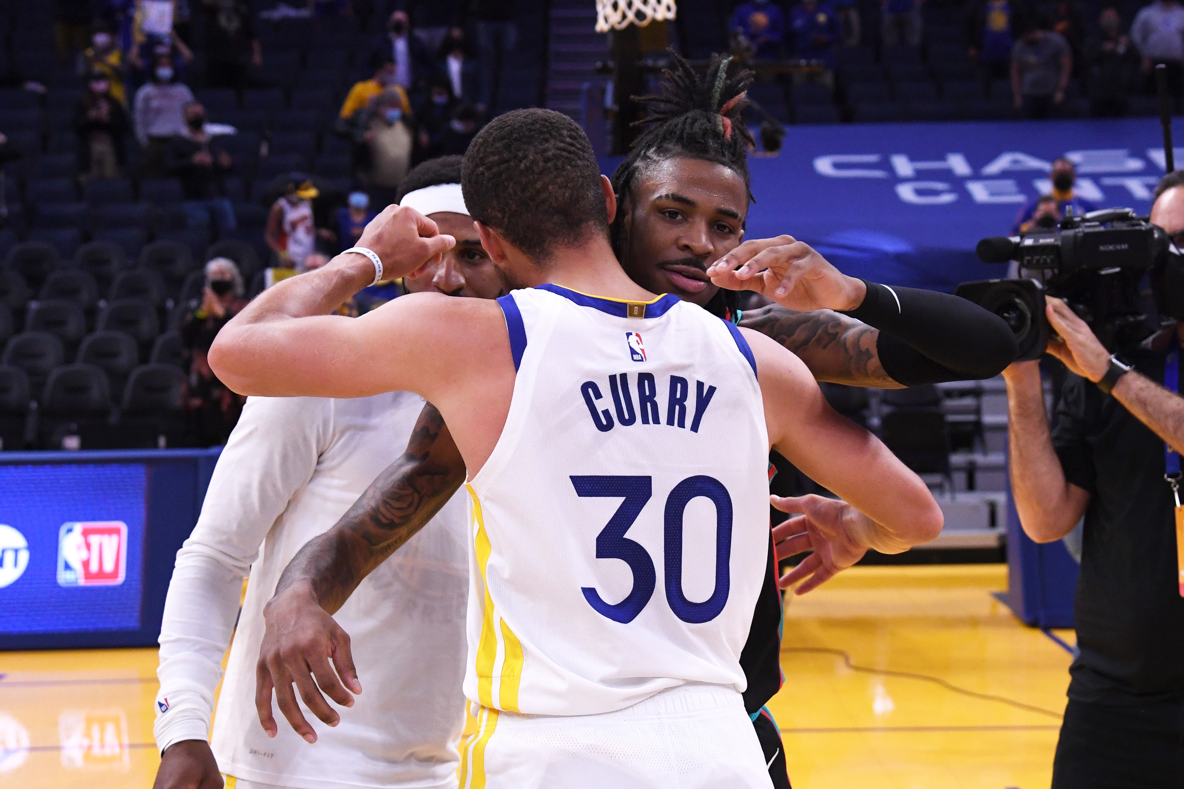 SAN FRANCISCO, CA - MAY 16: Ja Morant #12 of the Memphis Grizzlies hugs Stephen Curry #30 of the Golden State Warriors after the game on May 16, 2021 at Chase Center in San Francisco, California. NOTE TO USER: User expressly acknowledges and agrees that, by downloading and or using this photograph, user is consenting to the terms and conditions of Getty Images License Agreement. Mandatory Copyright Notice: Copyright 2021 NBAE (Photo by Noah Graham/NBAE via Getty Images)