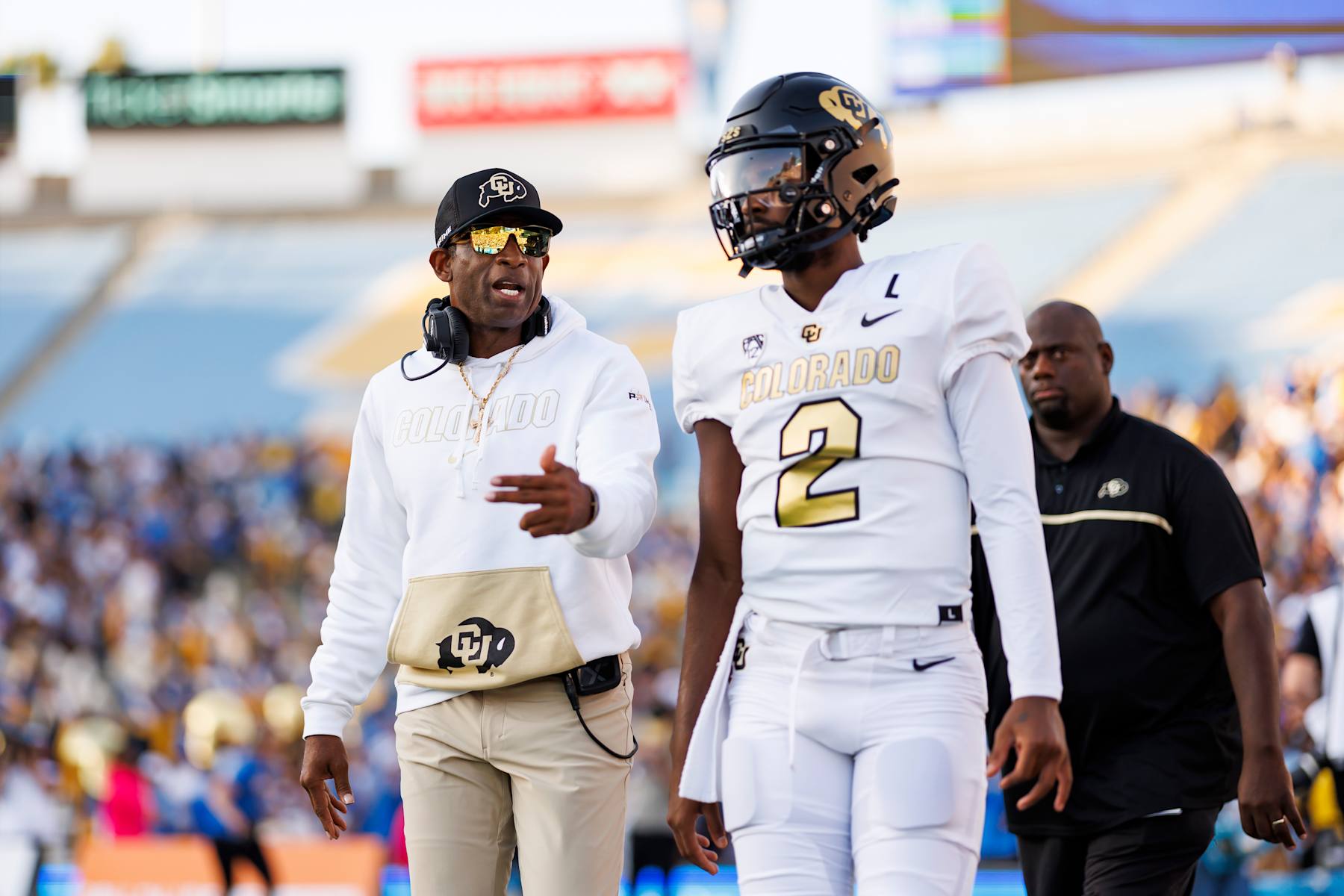 PASADENA, CALIFORNIA - OCTOBER 28: Head coach Deion Sanders and Shedeur Sanders #12 of the Colorado Buffaloes walk together prior to a game against the UCLA Bruins at Rose Bowl Stadium on October 28, 2023 in Pasadena, California. (Photo by Ryan Kang/Getty Images)