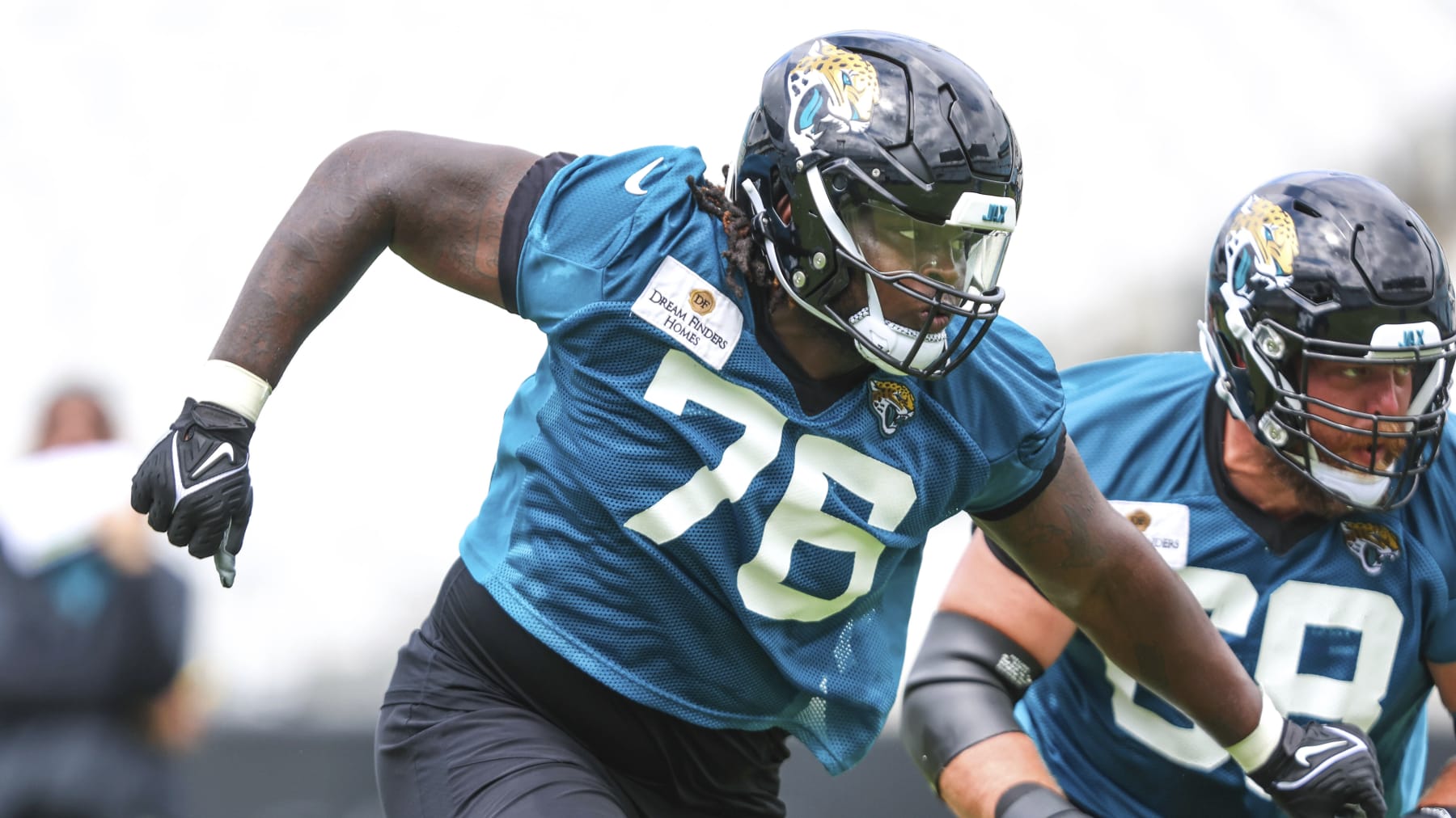 Jacksonville Jaguars offensive tackle Anton Harrison (76) sets a block during the NFL football team's OTA offseason workouts in Jacksonville, Fla., Monday, May 22, 2023. (AP Photo/Gary McCullough)
