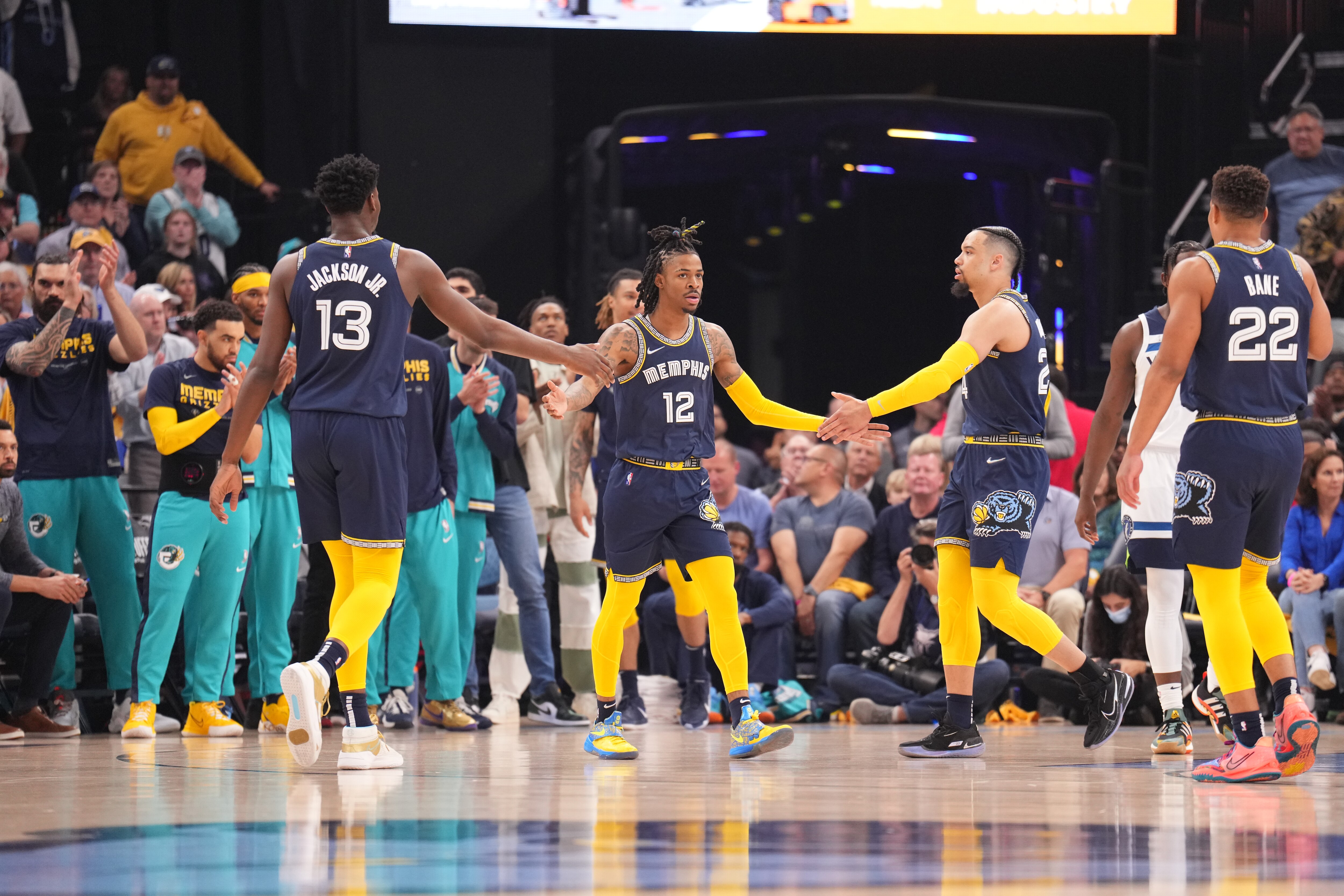 MEMPHIS, TN - APRIL 26: Jaren Jackson Jr. #13 of the Memphis Grizzlies, Ja Morant #12 of the Memphis Grizzlies, and Dillon Brooks #24 of the Memphis Grizzlies high-five during Round 1 Game 5 on April 26, 2022 at FedExForum in Memphis, Tennessee. NOTE TO USER: User expressly acknowledges and agrees that, by downloading and/or using this Photograph, user is consenting to the terms and conditions of the Getty Images License Agreement. Mandatory Copyright Notice: Copyright 2022 NBAE (Photo by Jesse D. Garrabrant/NBAE via Getty Images)