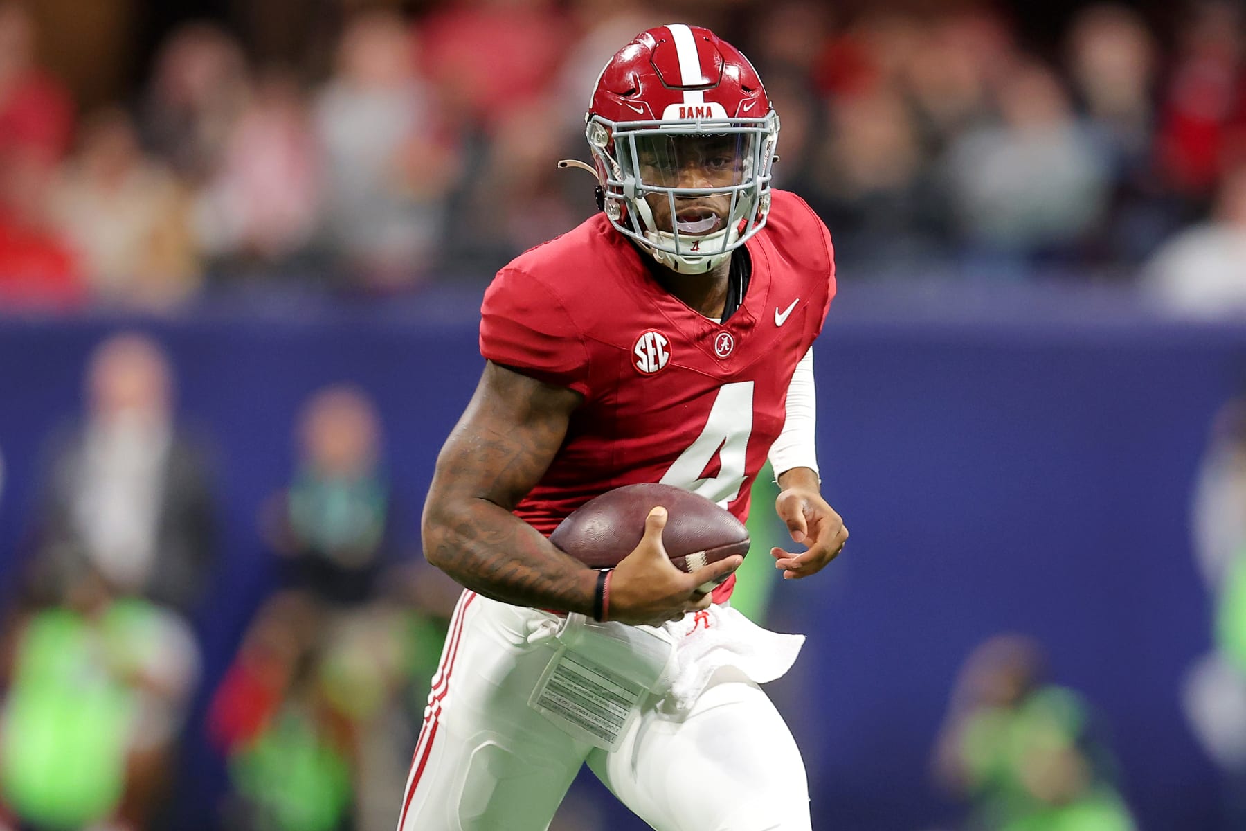 ATLANTA, GEORGIA - DECEMBER 02: Jalen Milroe #4 of the Alabama Crimson Tide runs out of the pocket during the first quarter against the Georgia Bulldogs in the SEC Championship at Mercedes-Benz Stadium on December 02, 2023 in Atlanta, Georgia. (Photo by Kevin C. Cox/Getty Images)