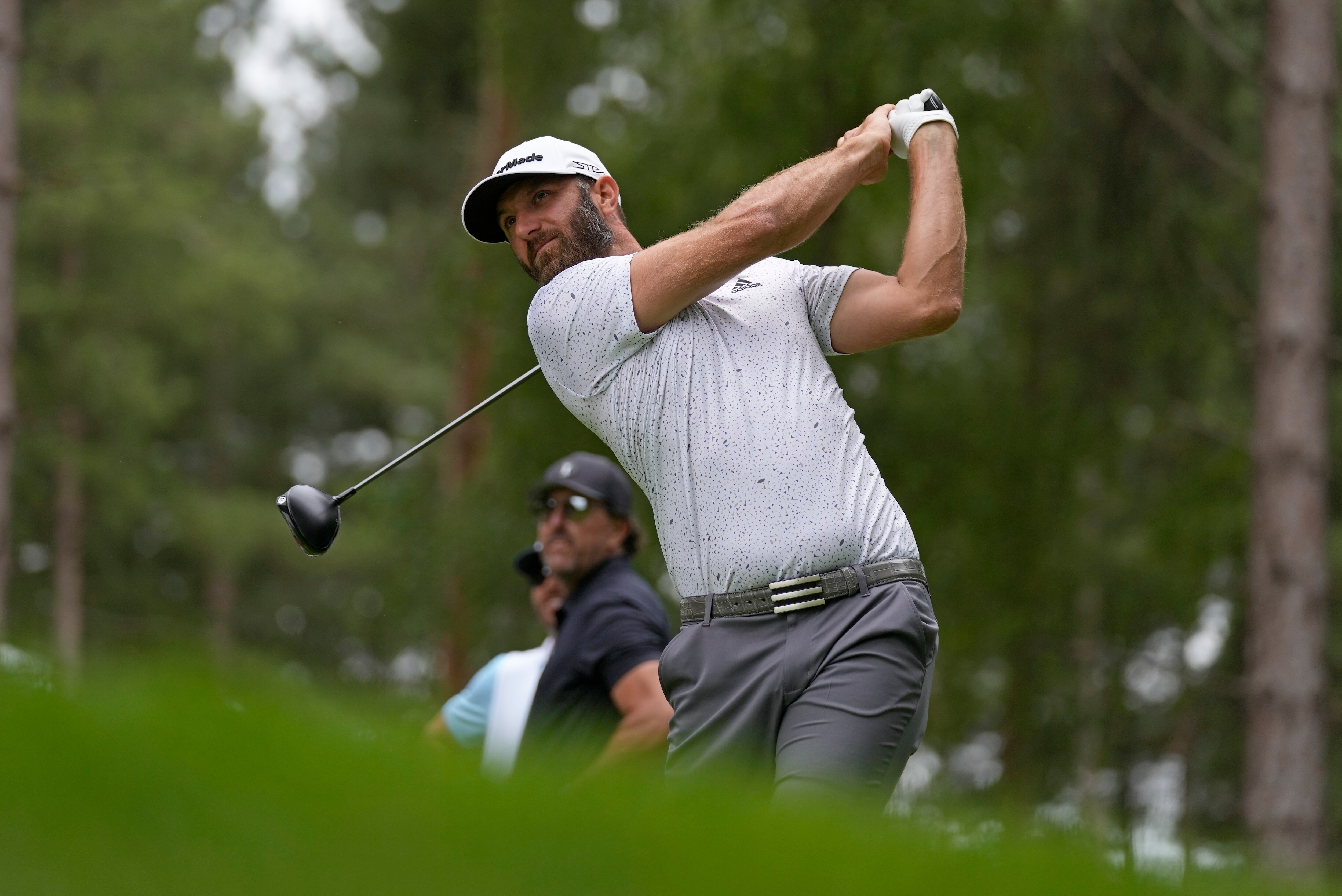 Dustin Johnson of the United States plays from the 4th tee during the first round of the inaugural LIV Golf Invitational at the Centurion Club in St. Albans, England, Thursday, June 9, 2022. (AP Photo/Alastair Grant)