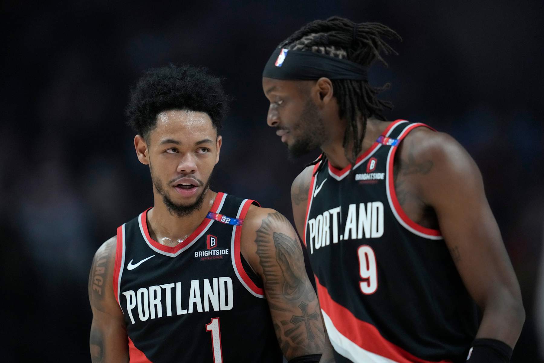 PORTLAND, OREGON - DECEMBER 01: Anfernee Simons #1 talks with Jerami Grant #9 of the Portland Trail Blazers during the first half against the Dallas Mavericks at Moda Center on December 01, 2024 in Portland, Oregon. NOTE TO USER: User expressly acknowledges and agrees that, by downloading and or using this photograph, User is consenting to the terms and conditions of the Getty Images License Agreement. (Photo by Soobum Im/Getty Images)