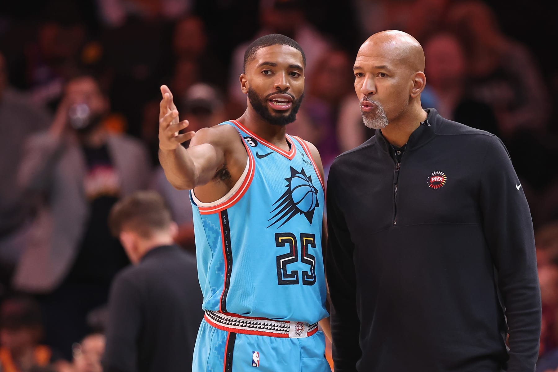 PHOENIX, ARIZONA - NOVEMBER 22: Mikal Bridges #25 of the Phoenix Suns talks with head coach Monty Williams during the second half of the NBA game against the Los Angeles Lakers at Footprint Center on November 22, 2022 in Phoenix, Arizona. The Suns defeated the Lakers 115-105. NOTE TO USER: User expressly acknowledges and agrees that, by downloading and or using this photograph, User is consenting to the terms and conditions of the Getty Images License Agreement.  (Photo by Christian Petersen/Getty Images)