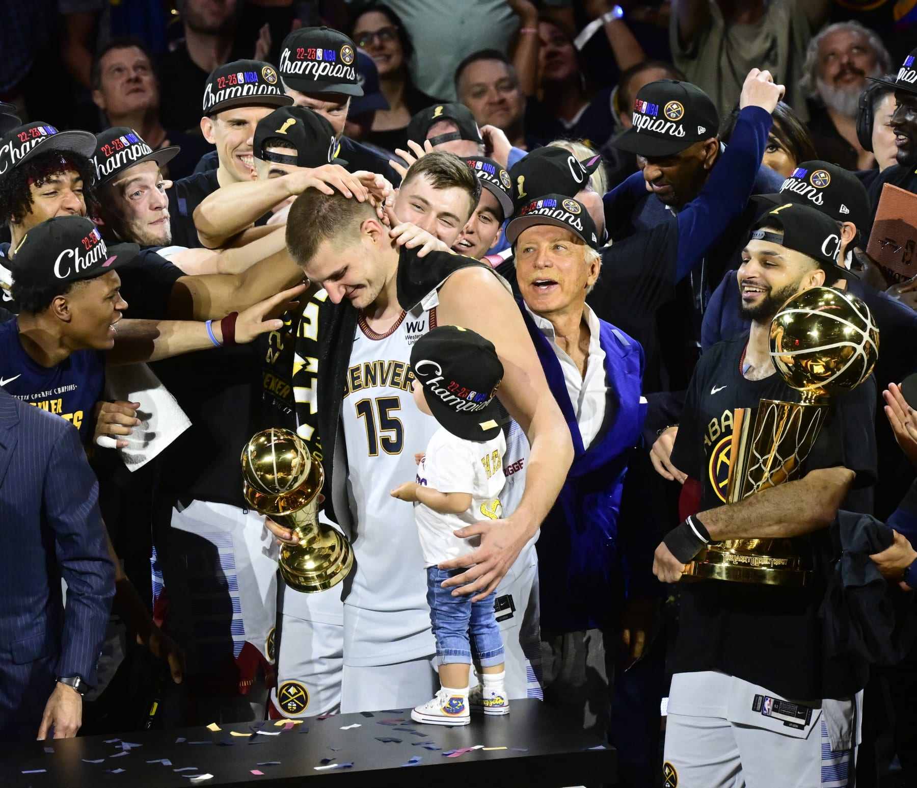 DENVER, CO - JUNE 12: NBA Finals MVP Nikola Jokic (15) of the Denver Nuggets holds the MVP trophy in one hand and his daughter Ognjena in the other on stage after defeating the Miami Heat at Ball Arena June 12, 2023. (Photo by Andy Cross/MediaNews Group/The Denver Post via Getty Images)