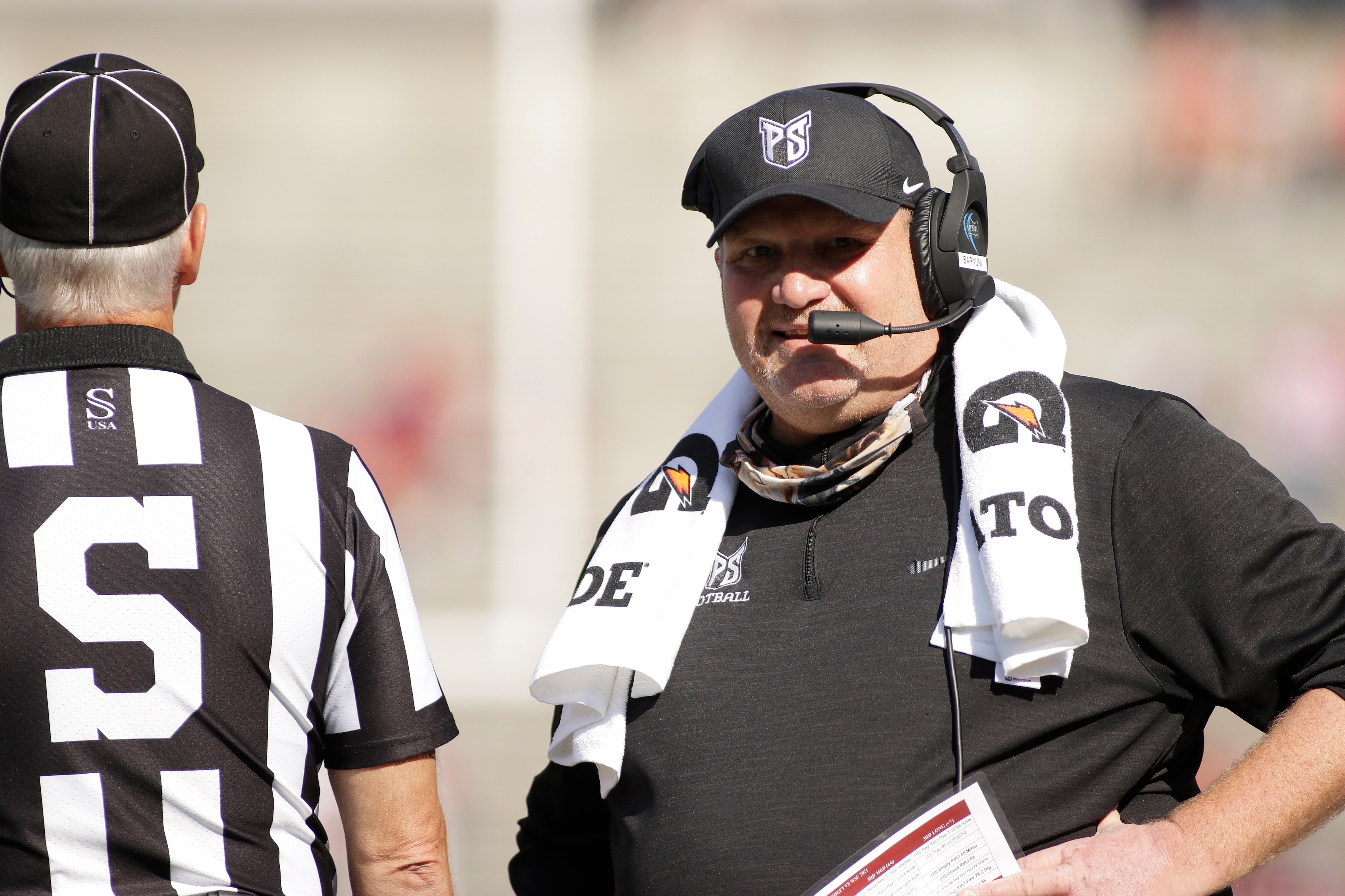 Portland State head coach Bruce Barnum, right, speaks with an official during the first half of an NCAA college football game against Washington State, Saturday, Sept. 11, 2021, in Pullman, Wash. (AP Photo/Young Kwak)