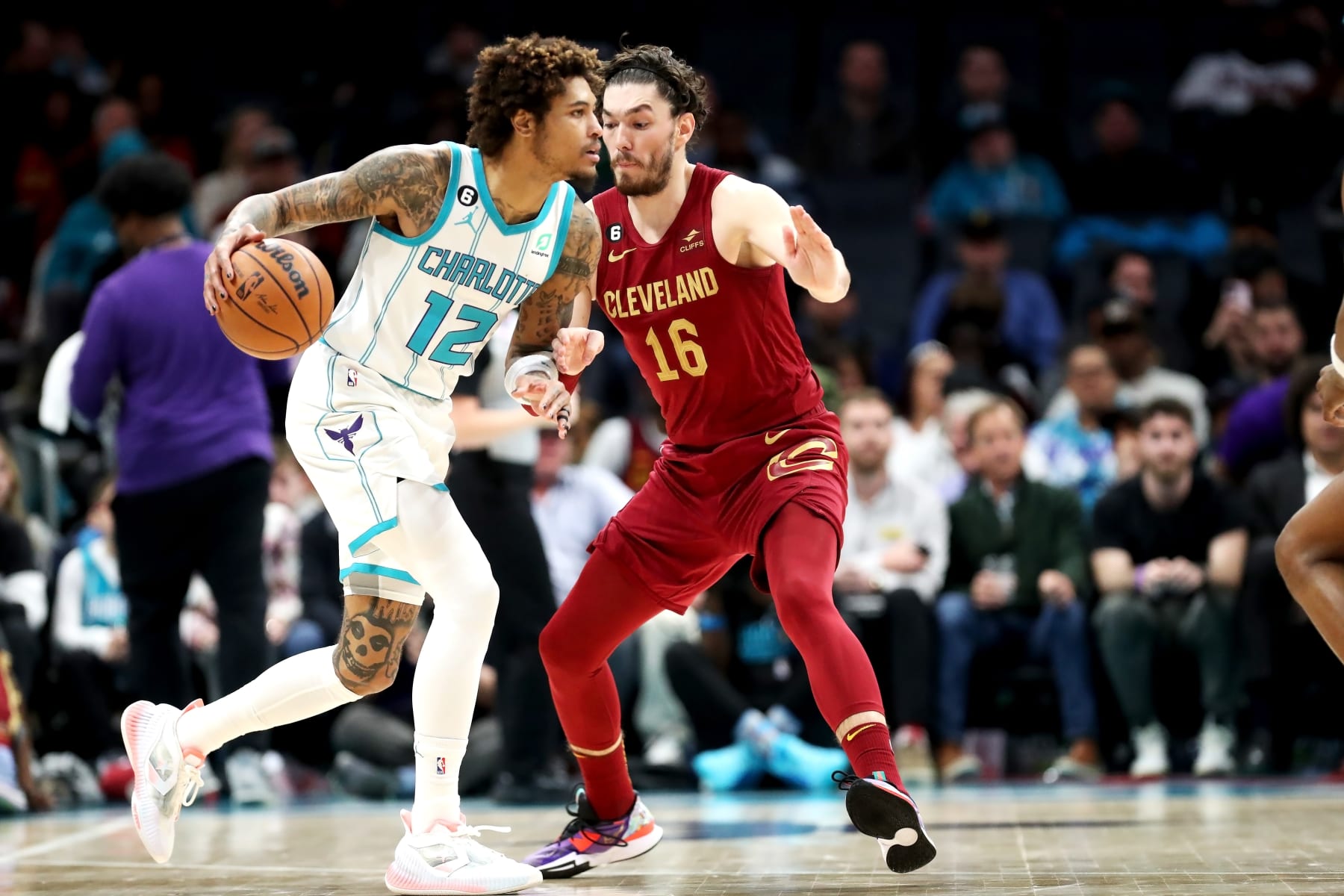 CHARLOTTE, NORTH CAROLINA - MARCH 14: Cedi Osman #16 of the Cleveland Cavaliers defends Kelly Oubre Jr. #12 of the Charlotte Hornets as he drives to the basket during the second half of a basketball game at Spectrum Center on March 14, 2023 in Charlotte, North Carolina. NOTE TO USER: User expressly acknowledges and agrees that, by downloading and or using this photograph, User is consenting to the terms and conditions of the Getty Images License Agreement. (Photo by David Jensen/Getty Images)