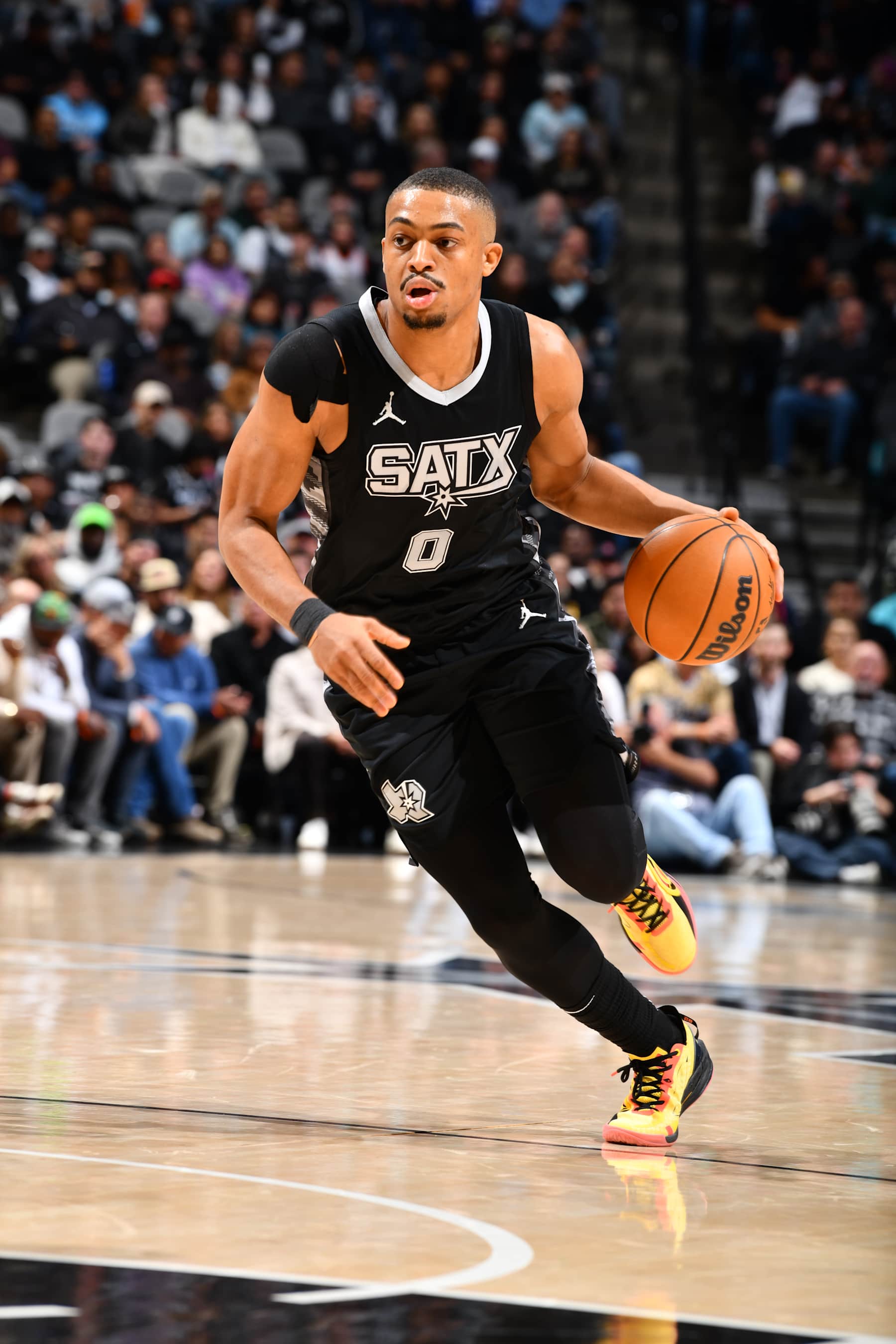 SAN ANTONIO, TX - JANUARY 15: Keldon Johnson #0 of the San Antonio Spurs dribbles the ball during the game against the Memphis Grizzlies on January 15, 2025 at the Frost Bank Center in San Antonio, Texas. NOTE TO USER: User expressly acknowledges and agrees that, by downloading and or using this photograph, user is consenting to the terms and conditions of the Getty Images License Agreement. Mandatory Copyright Notice: Copyright 2025 NBAE (Photos by Barry Gossage/NBAE via Getty Images)