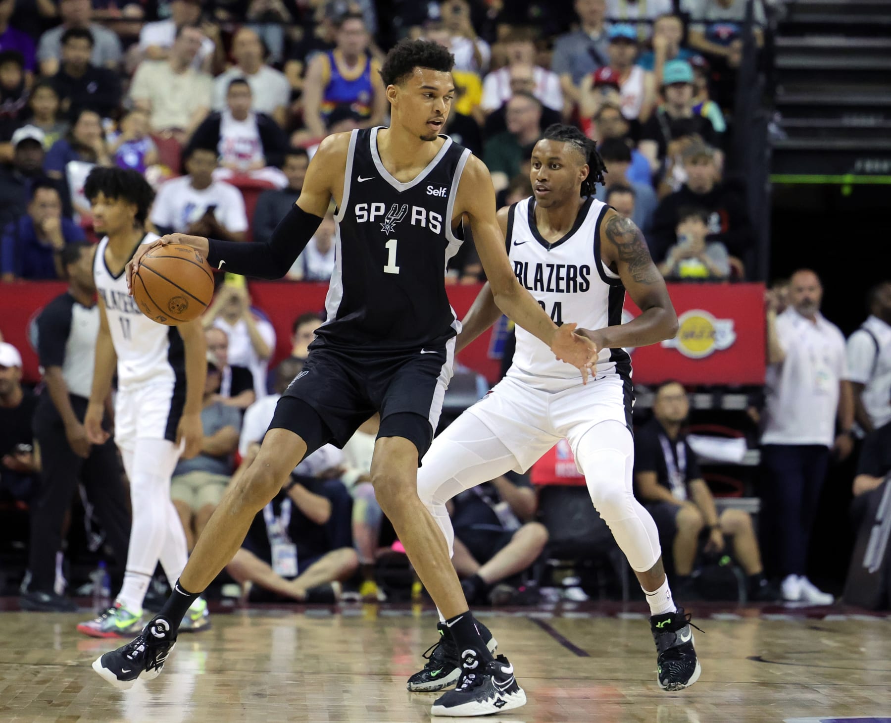LAS VEGAS, NEVADA - JULY 09: Victor Wembanyama #1 of the San Antonio Spurs is guarded by Jabari Walker #34 of the Portland Trail Blazers in the first half of a 2023 NBA Summer League game at the Thomas & Mack Center on July 09, 2023 in Las Vegas, Nevada. NOTE TO USER: User expressly acknowledges and agrees that, by downloading and or using this photograph, User is consenting to the terms and conditions of the Getty Images License Agreement. (Photo by Ethan Miller/Getty Images)