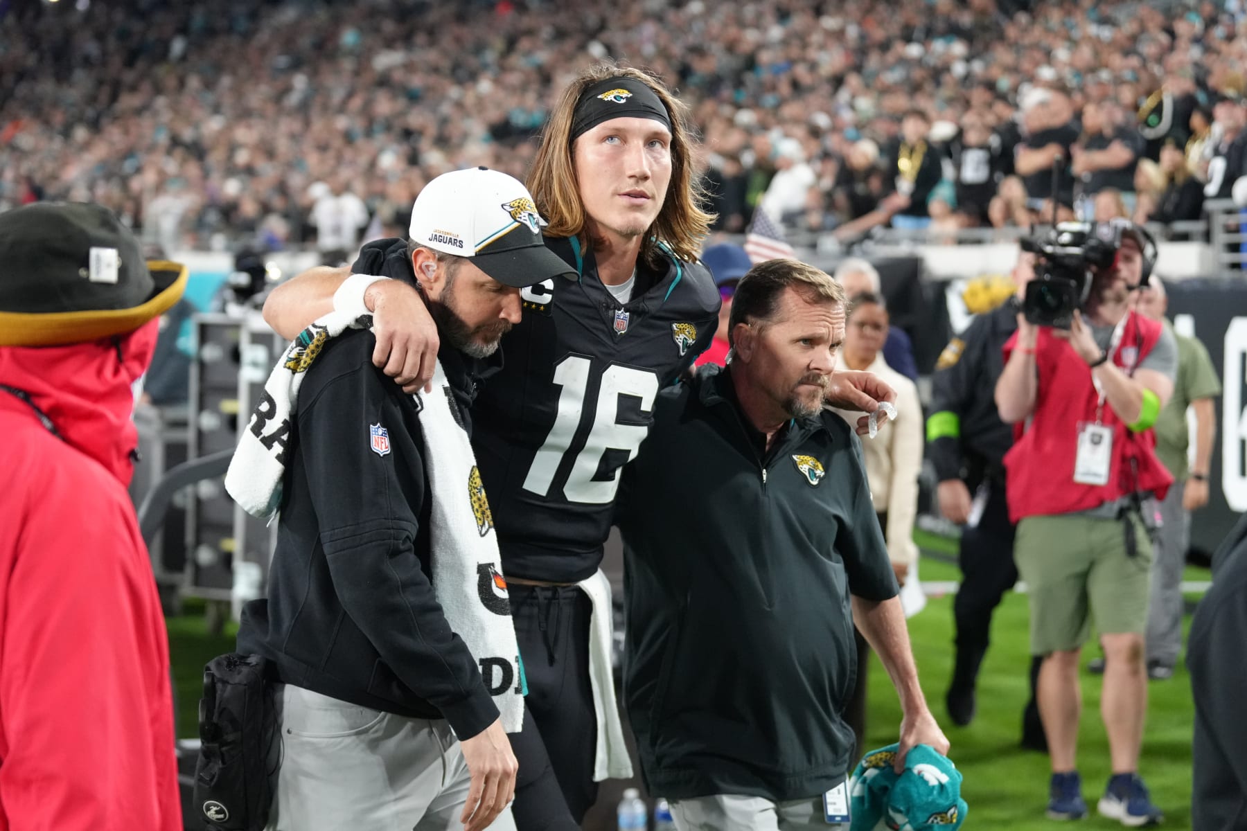 JACKSONVILLE, FL - DECEMBER 04: Jacksonville Jaguars quarterback Trevor Lawrence (16) is helped off of the field after being injured during the game between the Cincinnati Bengals and the Jacksonville Jaguars on Monday, December 4, 2023, EverBank Stadium, Jacksonville, Fla. (Photo by Peter Joneleit/Icon Sportswire via Getty Images)