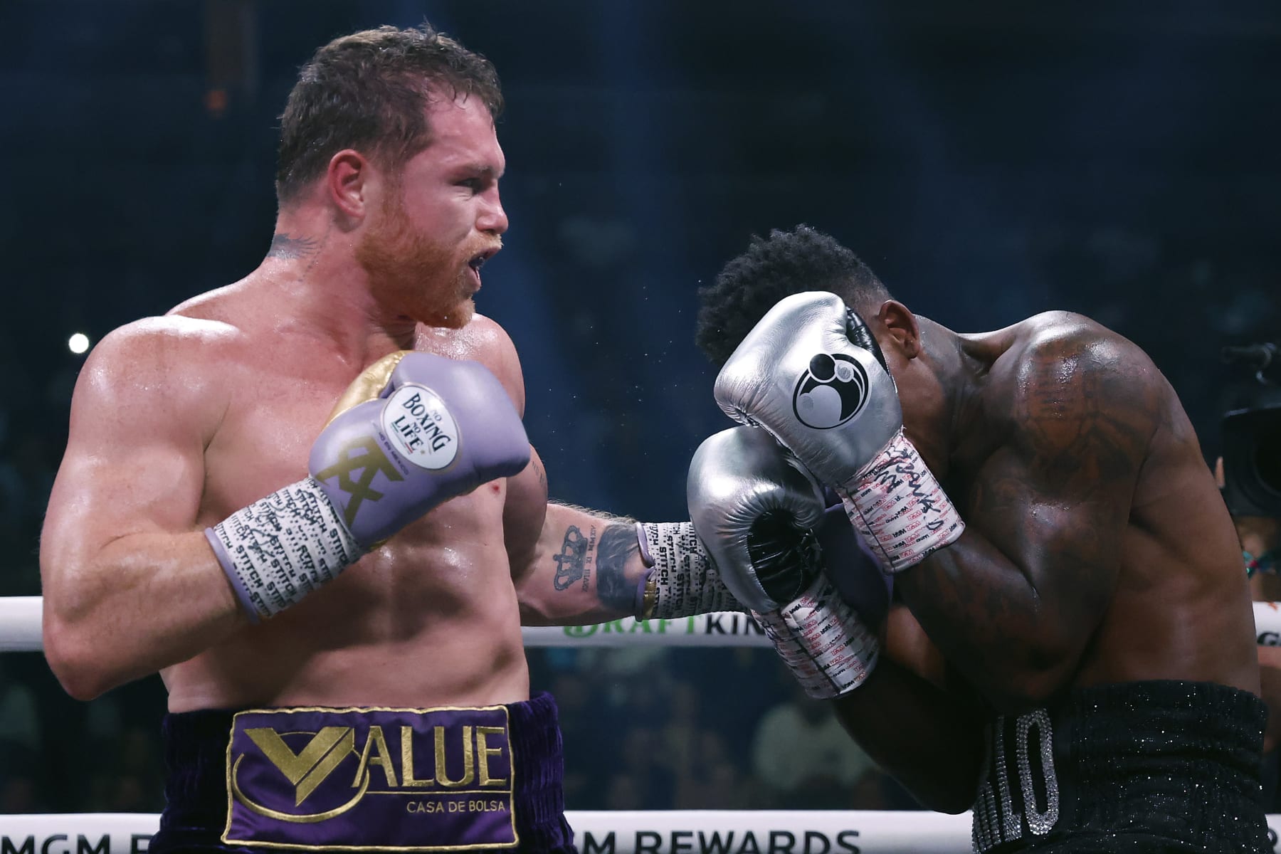 LAS VEGAS, NEVADA - SEPTEMBER 30:   Saul "Canelo" Alvarez of Mexico (purple/gold trunks) trades punches with Jermell Charlo (black trunks) during their super middleweight title fight at T-Mobile Arena on September 30, 2023 in Las Vegas, Nevada.  (Photo by Sarah Stier/Getty Images)