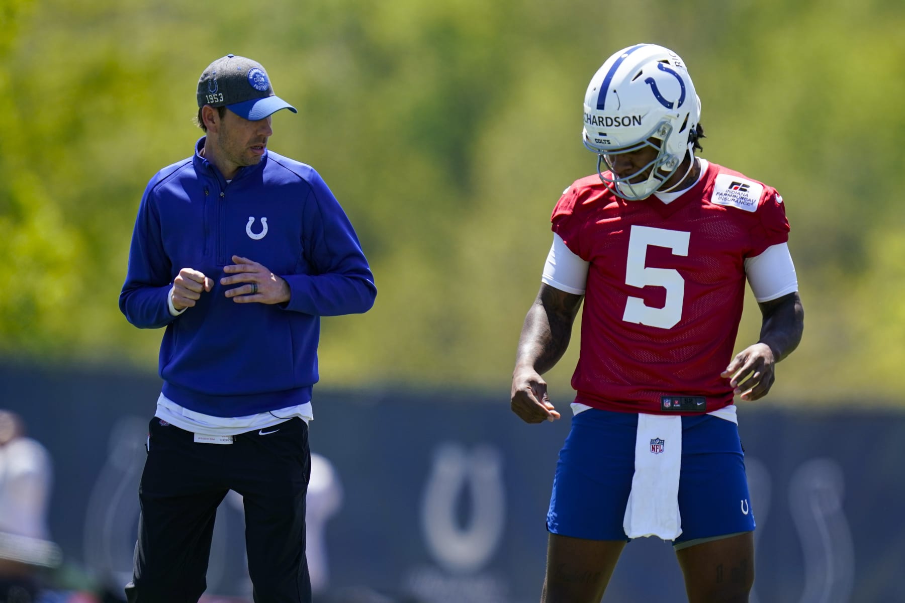 Indianapolis Colts quarterback Anthony Richardson(5) works on foot work with head coach Shane Steichen during a rookie camp at the NFL football team's practice facility in Indianapolis, Friday, May 5, 2023. (AP Photo/Michael Conroy)