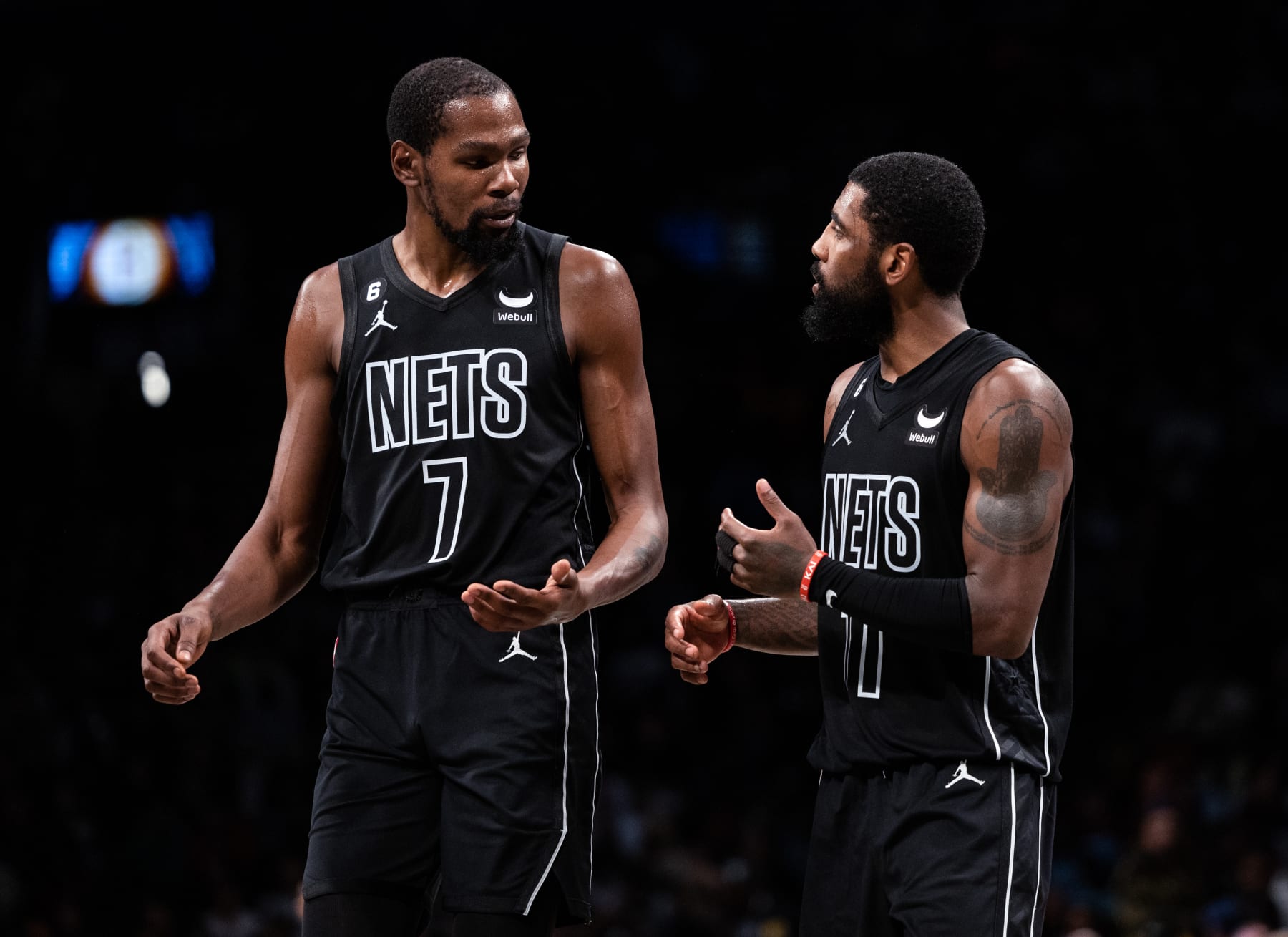 NEW YORK, NEW YORK - OCTOBER 31: Kevin Durant #7 speaks with Kyrie Irving #11 of the Brooklyn Nets during a break in the action during the fourth quarter of the game against the Indiana Pacers at Barclays Center on October 31, 2022 in New York City. NOTE TO USER: User expressly acknowledges and agrees that, by downloading and or using this photograph, User is consenting to the terms and conditions of the Getty Images License Agreement. (Photo by Dustin Satloff/Getty Images)