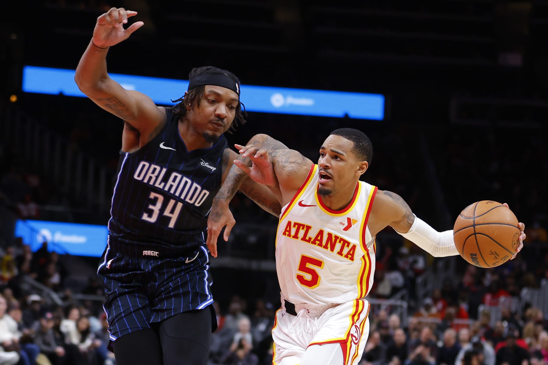 ATLANTA, GEORGIA - JANUARY 17: Dejounte Murray #5 of the Atlanta Hawks drives to the basket against Wendell Carter Jr. #34 of the Orlando Magic during the fourth quarter at State Farm Arena on January 17, 2024 in Atlanta, Georgia. NOTE TO USER: User expressly acknowledges and agrees that, by downloading and or using this photograph, User is consenting to the terms and conditions of the Getty Images License Agreement. (Photo by Todd Kirkland/Getty Images)