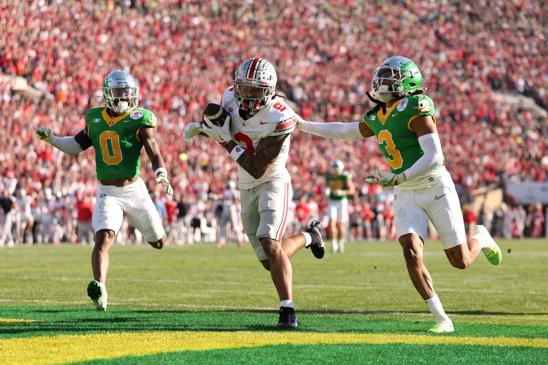 PASADENA, CALIFORNIA - JANUARY 01: Emeka Egbuka #2 of the Ohio State Buckeyes makes a touchdown catch against Brandon Johnson #3 of the Oregon Ducks during the first quarter during the Rose Bowl Game Presented by Prudential at Rose Bowl Stadium on January 01, 2025 in Pasadena, California. (Photo by Harry How/Getty Images)