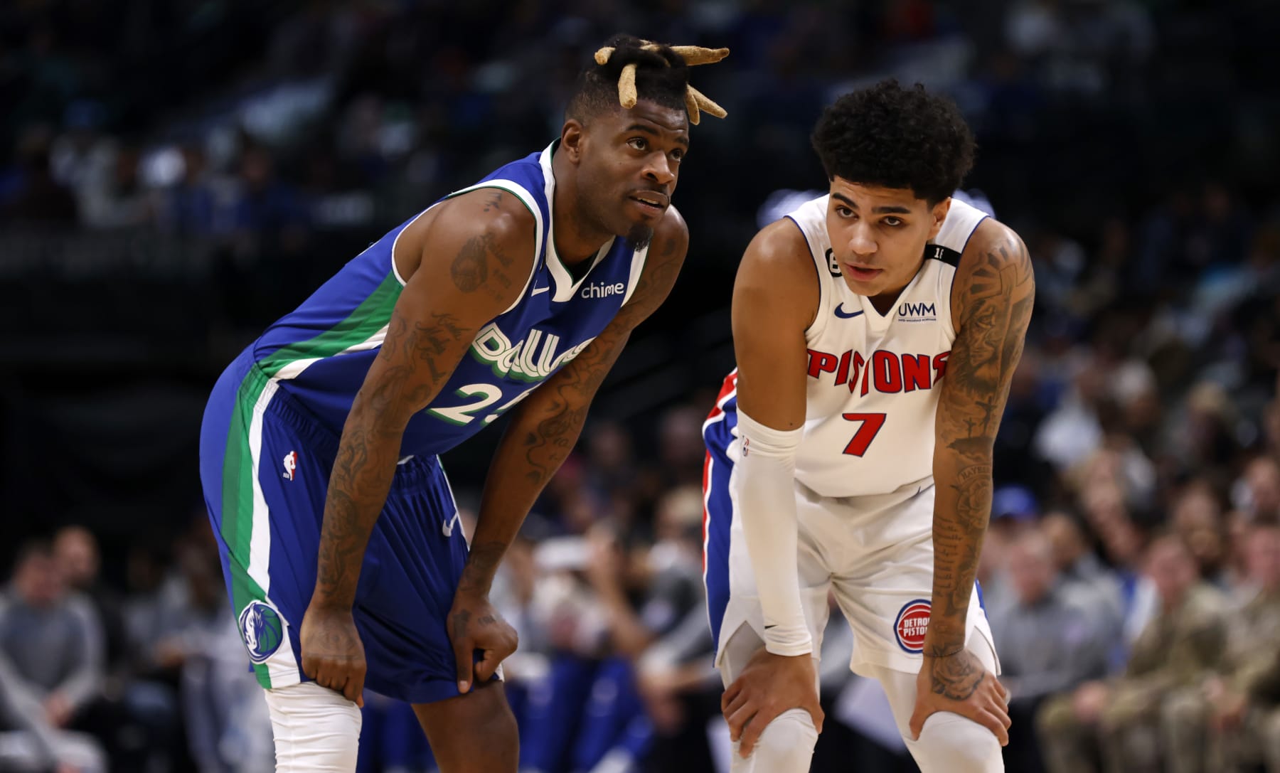 DALLAS, TX - JANUARY 30: Reggie Bullock #25 of the Dallas Mavericks  and Killian Hayes #7 of the Detroit Pistons talk in the first half at American Airlines Center on January 30, 2023 in Dallas, Texas. NOTE TO USER: User expressly acknowledges and agrees that, by downloading and or using this photograph, User is consenting to the terms and conditions of the Getty Images License Agreement. (Photo by Ron Jenkins/Getty Images)