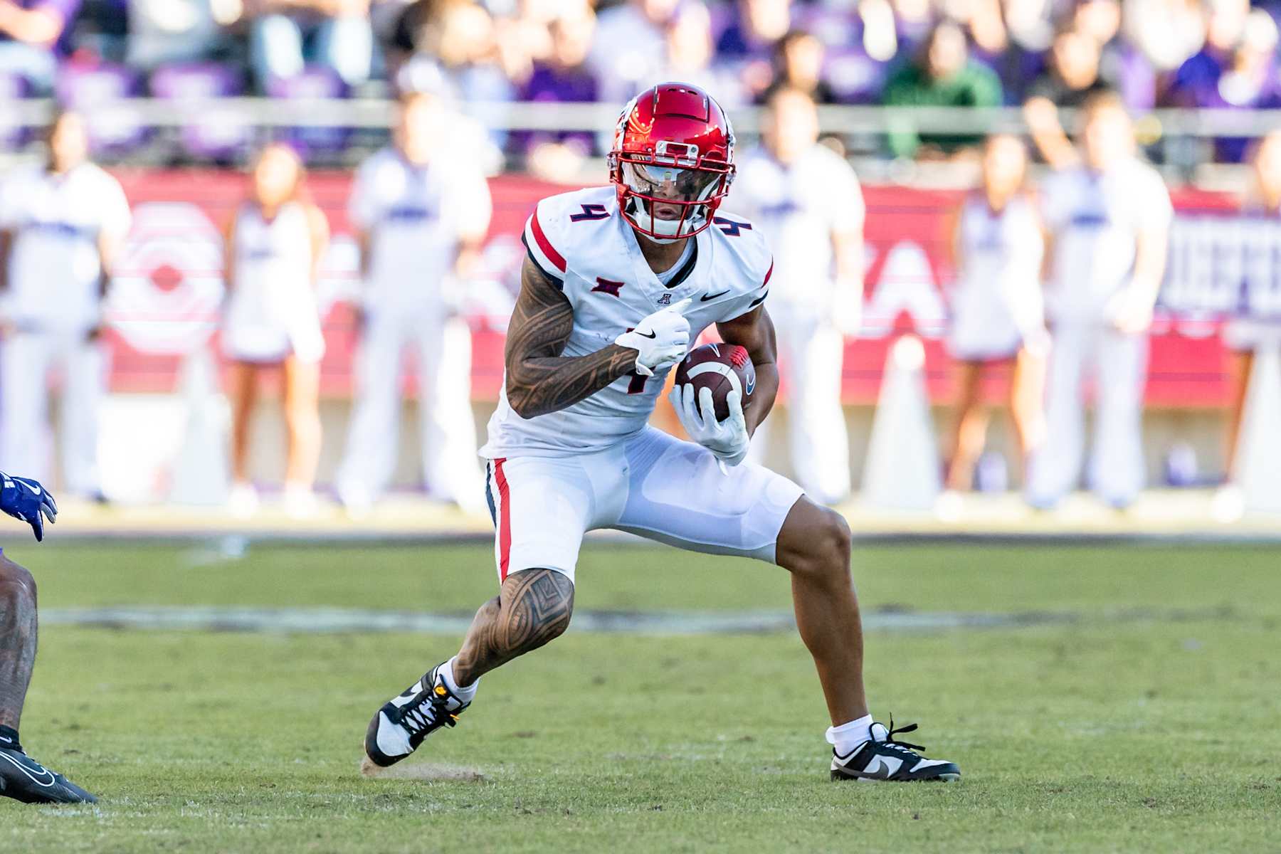 FORT WORTH, TX - NOVEMBER 23: Arizona Wildcats wide receiver Tetairoa McMillan (#4) turns up field after making a catch during the Big 12 college football game between the Arizona Wildcats and TCU Horned Frogs on November 23, 2024 at Amon G. Carter Stadium in Fort Worth, TX.  (Photo by Matthew Visinsky/Icon Sportswire via Getty Images)