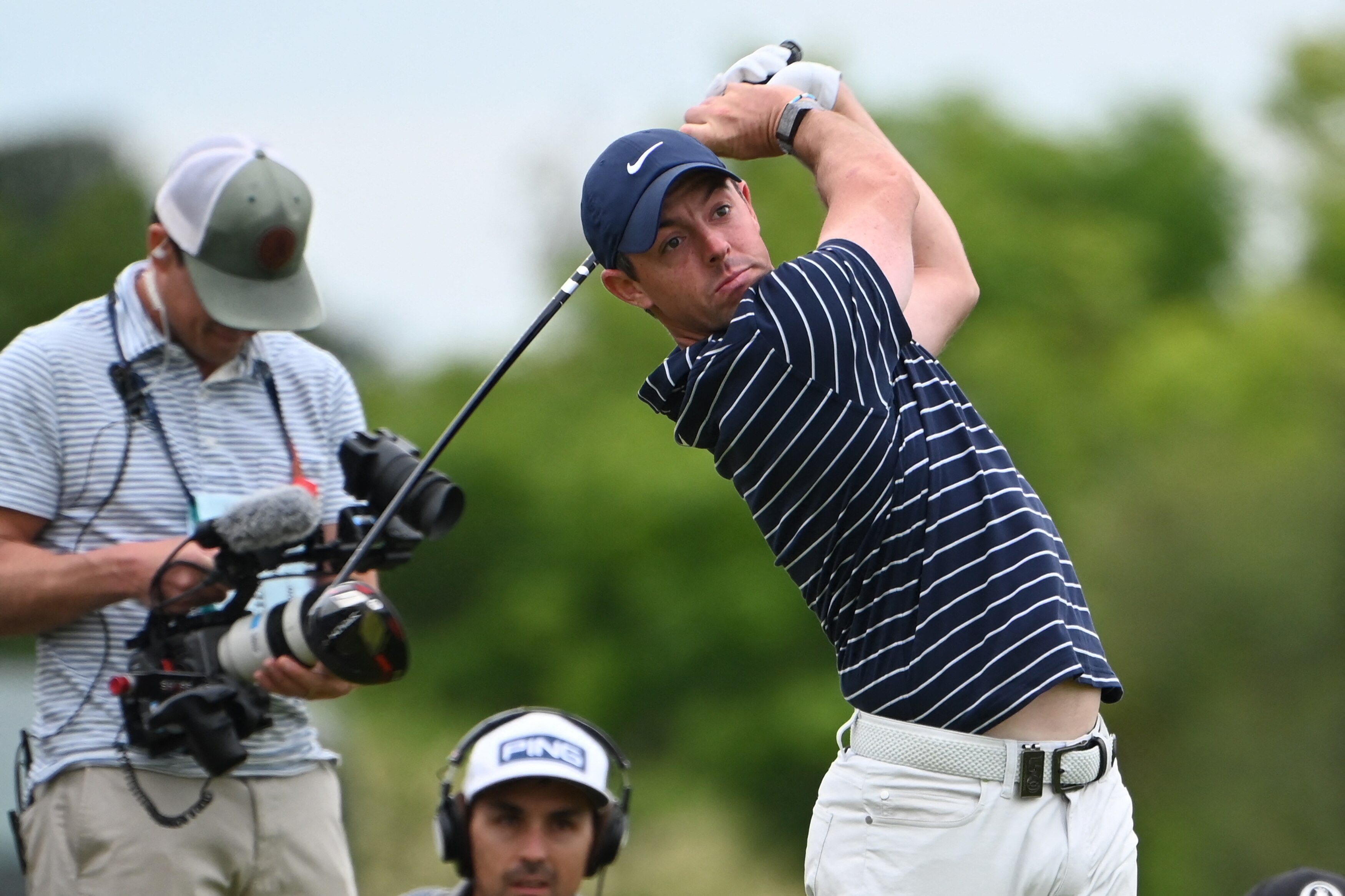 Winner of The Open in 2014, Northern Ireland's Rory McIlroy watches his shot from the 18th tee during The R&A Celebration of Champions, part of the build-up towards The 150th British Open Golf Championship on The Old Course at St Andrews in Scotland, on July 11, 2022. - The Open's Champion Golfers, women's Major Champions, male and female amateur Champions, and golfers with disability Champions compete in a four-hole challenge over the 1st, 2nd, 17th, and 18th holes of the Old Course.  - RESTRICTED TO EDITORIAL USE (Photo by Paul ELLIS / AFP) / RESTRICTED TO EDITORIAL USE (Photo by PAUL ELLIS/AFP via Getty Images)