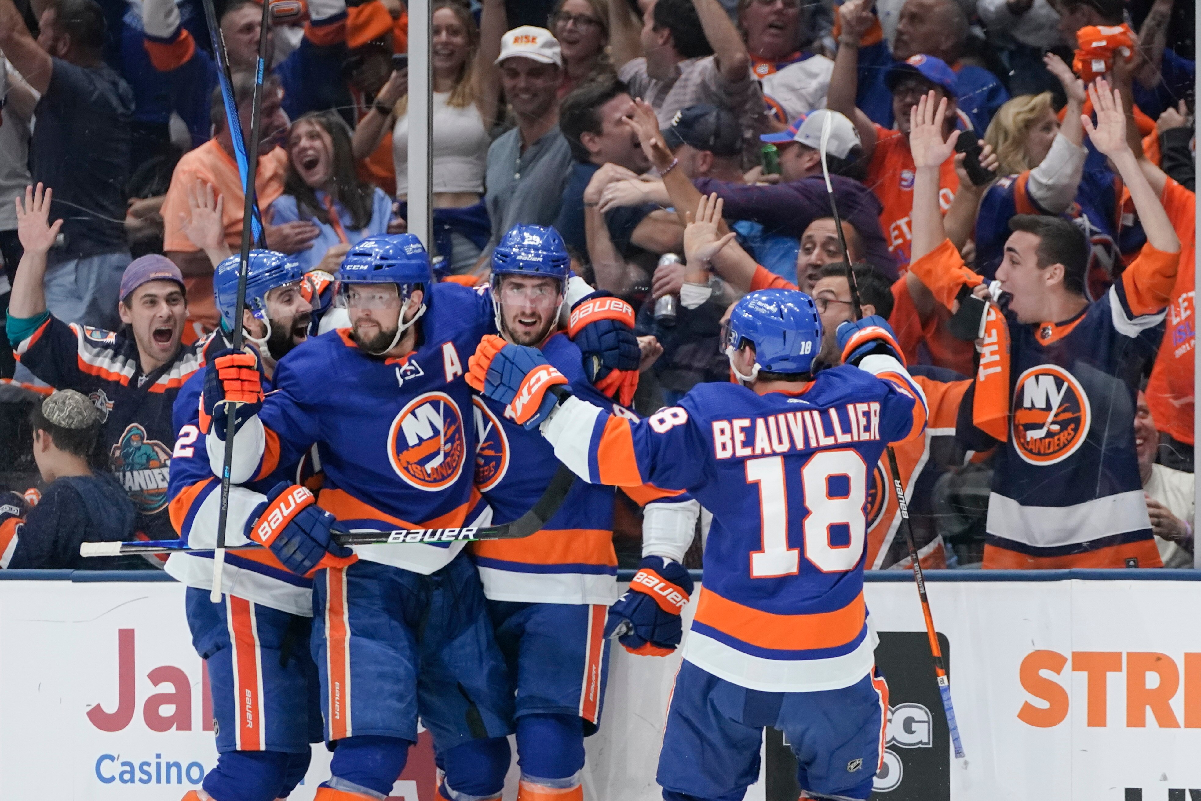 Fans watch New York Islanders' Brock Nelson, second from right celebrates with teammates after scoring a goal during the second period of Game 6 during an NHL hockey second-round playoff series against the Boston Bruins Wednesday, June 9, 2021, in Uniondale, N.Y. (AP Photo/Frank Franklin II)