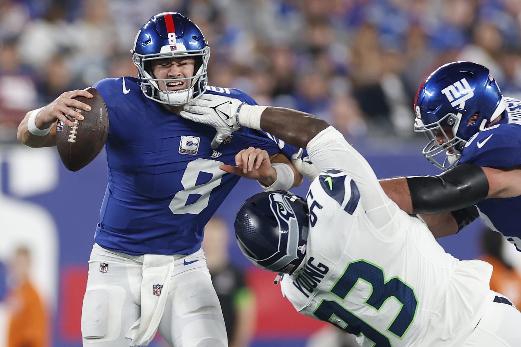 EAST RUTHERFORD, NEW JERSEY - OCTOBER 02: Daniel Jones #8 of the New York Giants is hit by Cameron Young #93 of the Seattle Seahawks during the second half at MetLife Stadium on October 02, 2023 in East Rutherford, New Jersey. (Photo by Sarah Stier/Getty Images)