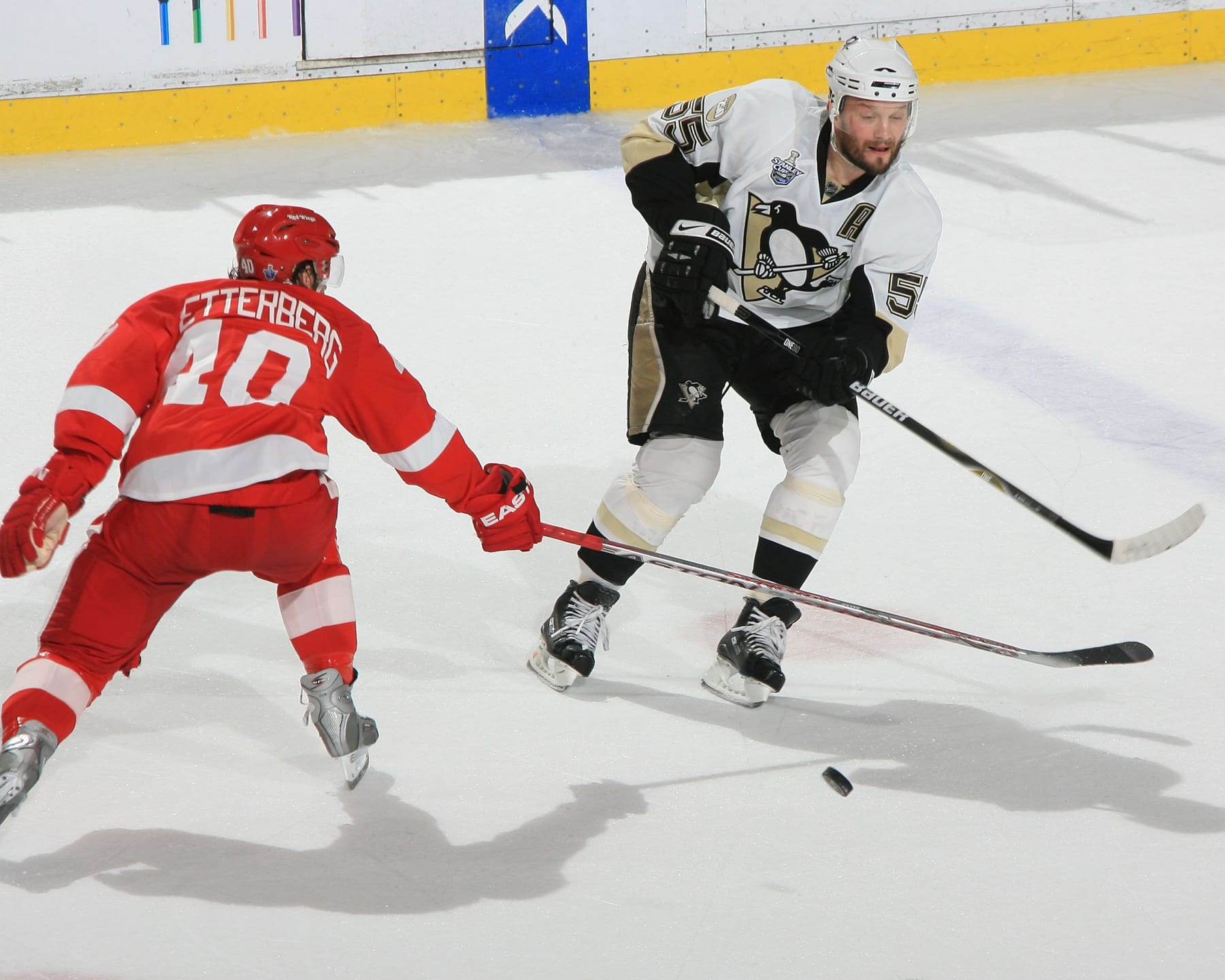DETROIT - MAY 26:  Sergei Gonchar #55 of the Pittsburgh Penguins passes the puck under the stick of Henrik Zetterberg #40 of the Detroit Red Wings chases during game two of the 2008 NHL Stanley Cup Finals at Joe Louis Arena on May 26, 2008 in Detroit, Michigan. The Wings won 3-0  (Photo by Dave Reginek/NHLI via Getty Images)