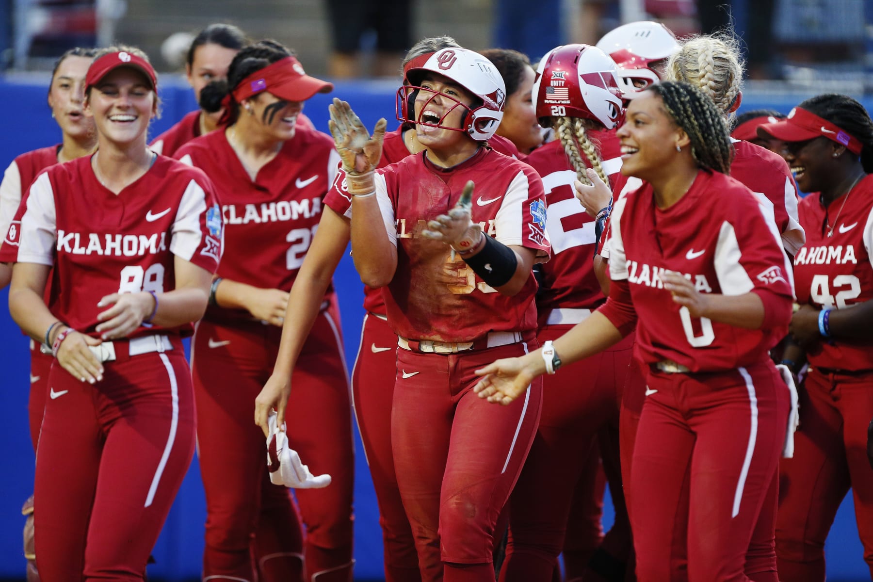OKLAHOMA CITY, OK - JUNE 9:  Alyssa Brito #33 celebrates after scoring on  a three-run homer run by Kinzie Hansen #9 of the Oklahoma Sooners to secure the lead at 6-2 against the Texas Longhorns in the fifth inning during the NCAA Women's College World Series finals at the USA Softball Hall of Fame Complex on June 9, 2022 in Oklahoma City, Oklahoma.  Oklahoma won the NCAA Championship with a 10-5 victory.  (Photo by Brian Bahr/Getty Images)
