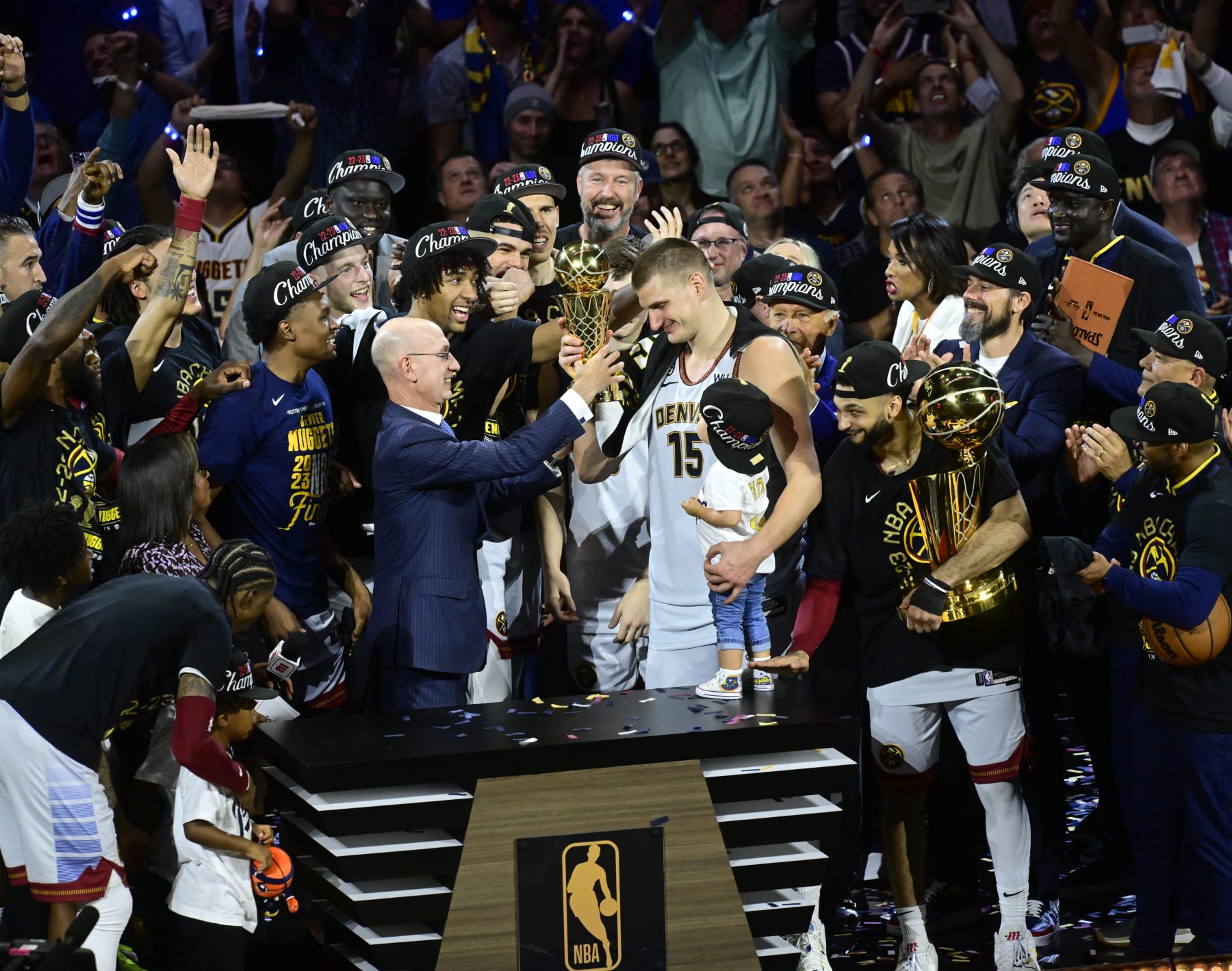 DENVER, CO - JUNE 12: NBA commissioner Adam Silver hands over MVP trophy to Nikola Jokic (15) of the Denver Nuggets who holds his daughter Ognjena, after defeating the Miami Heat 94-89 to win the championship at Ball Arena June 12, 2023. (Photo by Andy Cross/MediaNews Group/The Denver Post via Getty Images)