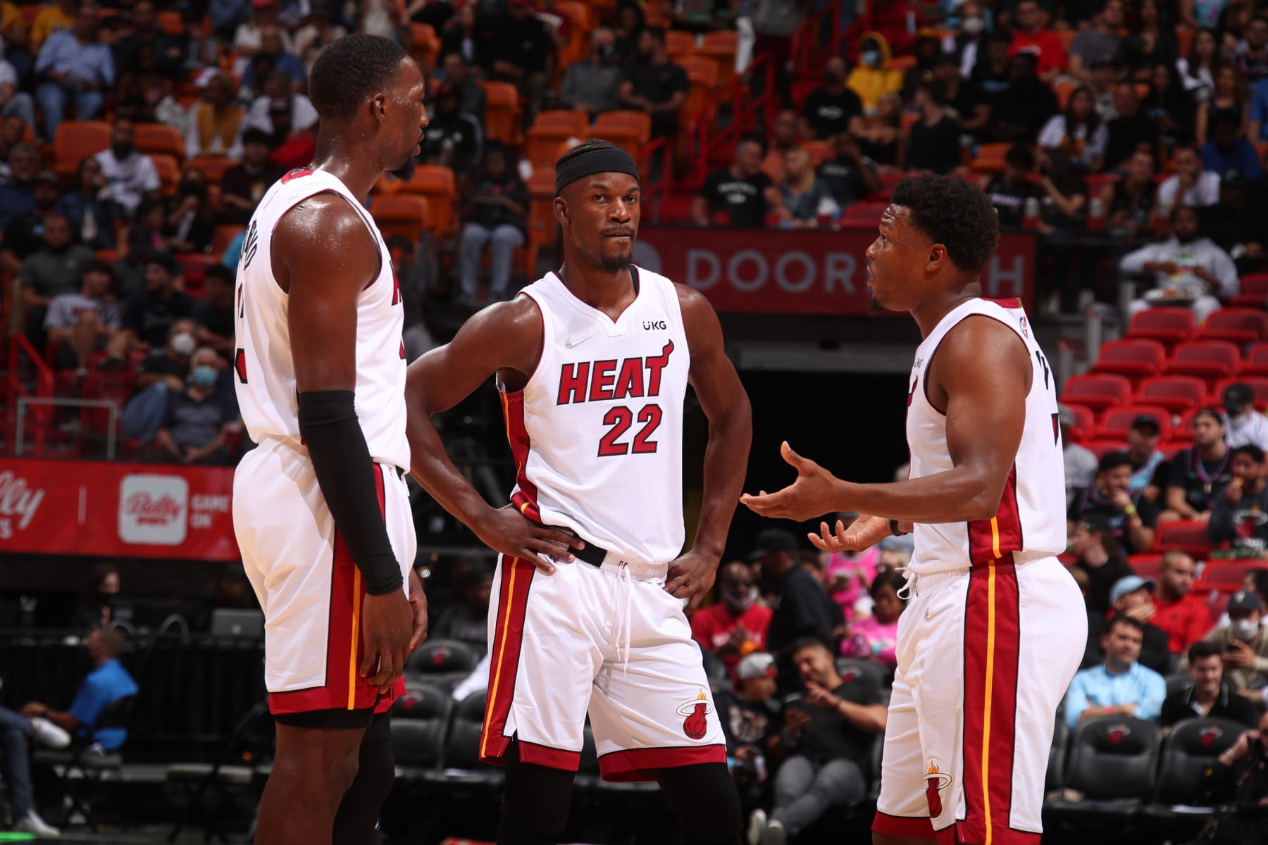 MIAMI, FL - OCTOBER 25: Bam Adebayo #13, Jimmy Butler #22, and Kyle Lowry #7 of the Miami Heat talk during the game against the Orlando Magic on October 25, 2021 at American Airlines Arena in Miami, Florida. NOTE TO USER: User expressly acknowledges and agrees that, by downloading and or using this Photograph, user is consenting to the terms and conditions of the Getty Images License Agreement. Mandatory Copyright Notice: Copyright 2021 NBAE (Photo by Issac Baldizon/NBAE via Getty Images)