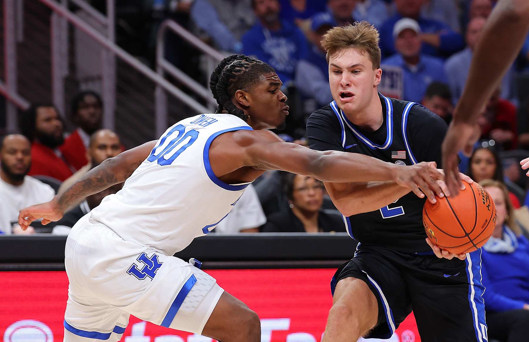 ATLANTA, GEORGIA - NOVEMBER 12:  Cooper Flagg #2 of the Duke Blue Devils drives against Otega Oweh #00 of the Kentucky Wildcats during the first half of the State Farm Champions Classic between the Kentucky Wildcats and Duke Blue Devils at State Farm Arena on November 12, 2024 in Atlanta, Georgia. (Photo by Kevin C. Cox/Getty Images)