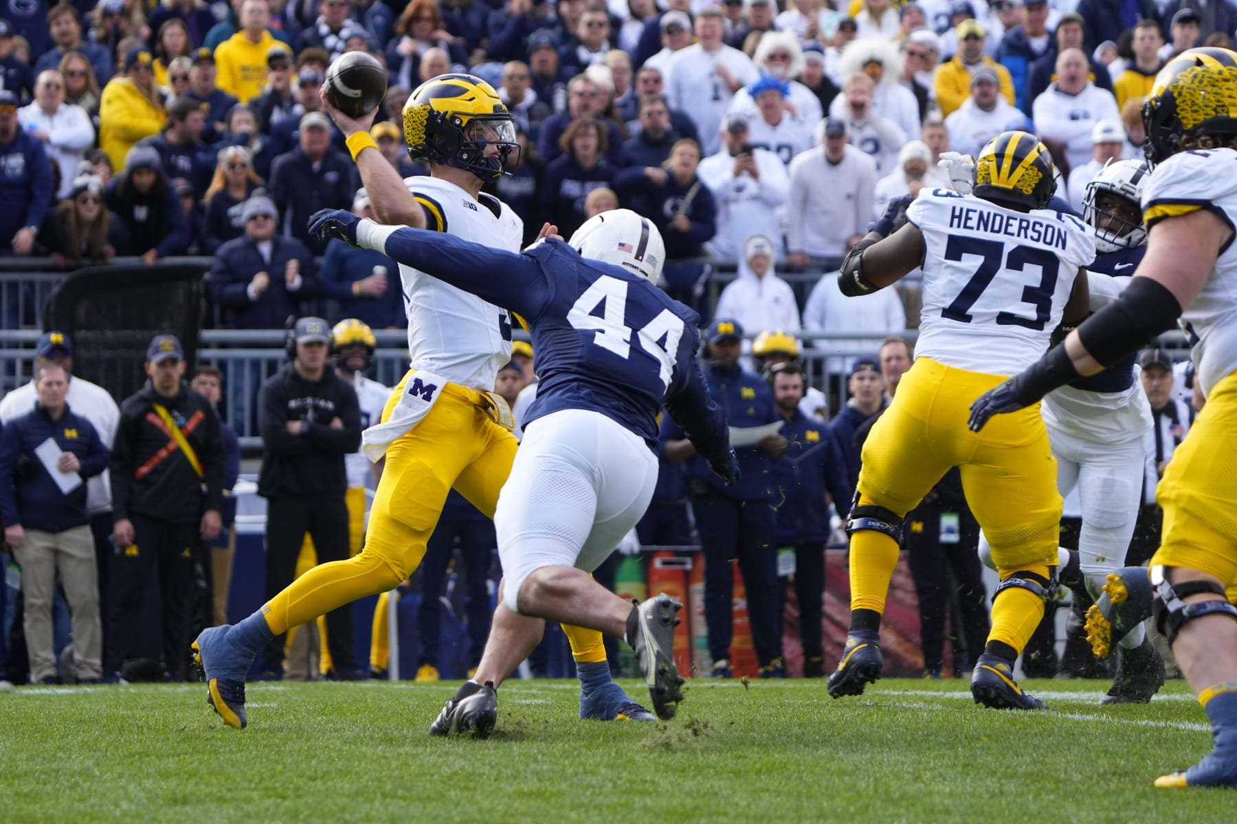 UNIVERSITY PARK, PA - NOVEMBER 11: Michigan Wolverines Quarterback J.J. McCarthy (9) throws the ball with Penn State Nittany Lions Defensive End Chop Robinson (44) applying pressure during the first half of the College Football game between the Michigan Wolverines and the Penn State Nittany Lions on November 11, 2023, at Beaver Stadium in University Park, PA. (Photo by Gregory Fisher/Icon Sportswire via Getty Images)