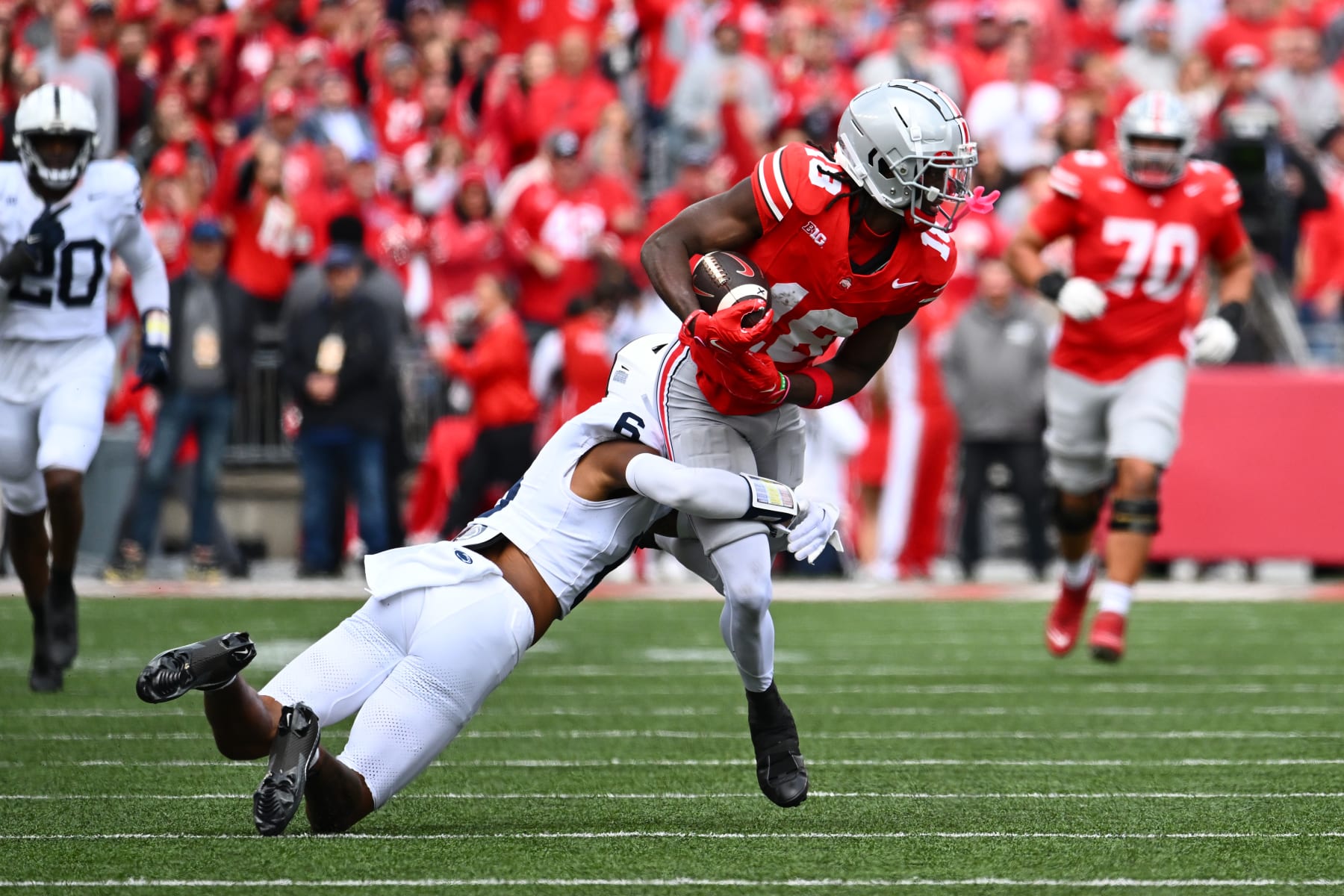 COLUMBUS, OHIO - OCTOBER 21: Marvin Harrison Jr. #18 of the Ohio State Buckeyes is tackled by Zakee Wheatley #6 of the Penn State Nittany Lions during the second quarter of a game at Ohio Stadium on October 21, 2023 in Columbus, Ohio. (Photo by Ben Jackson/Getty Images)