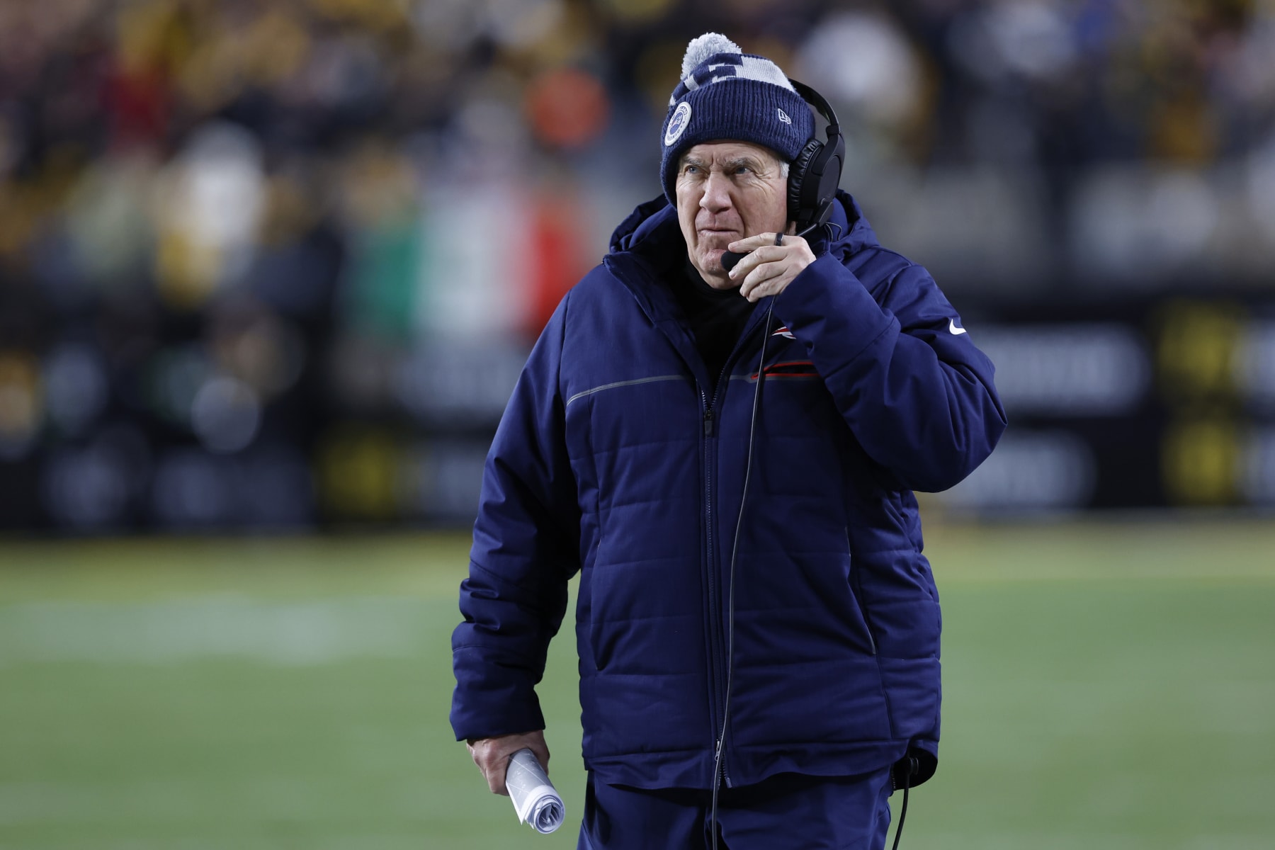 Pittsburgh, PA - December 7: New England Patriots head coach Bill Belichick adjusts his headset. The Patriots beat the Pittsburgh Steelers, 21-18. (Photo by Danielle Parhizkaran/The Boston Globe via Getty Images)