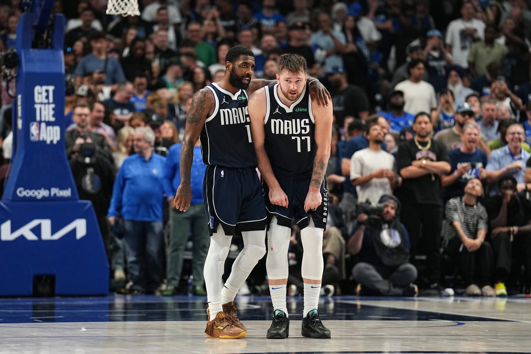 DALLAS, TX - MAY 26: Kyrie Irving #11 embraces Luka Doncic #77 of the Dallas Mavericks during the game against the Minnesota Timberwolves during Game 3 of the Western Conference Finals of the 2024 NBA Playoffs on May 26, 2024 at the American Airlines Center in Dallas, Texas. NOTE TO USER: User expressly acknowledges and agrees that, by downloading and or using this photograph, User is consenting to the terms and conditions of the Getty Images License Agreement. Mandatory Copyright Notice: Copyright 2024 NBAE (Photo by Glenn James/NBAE via Getty Images)