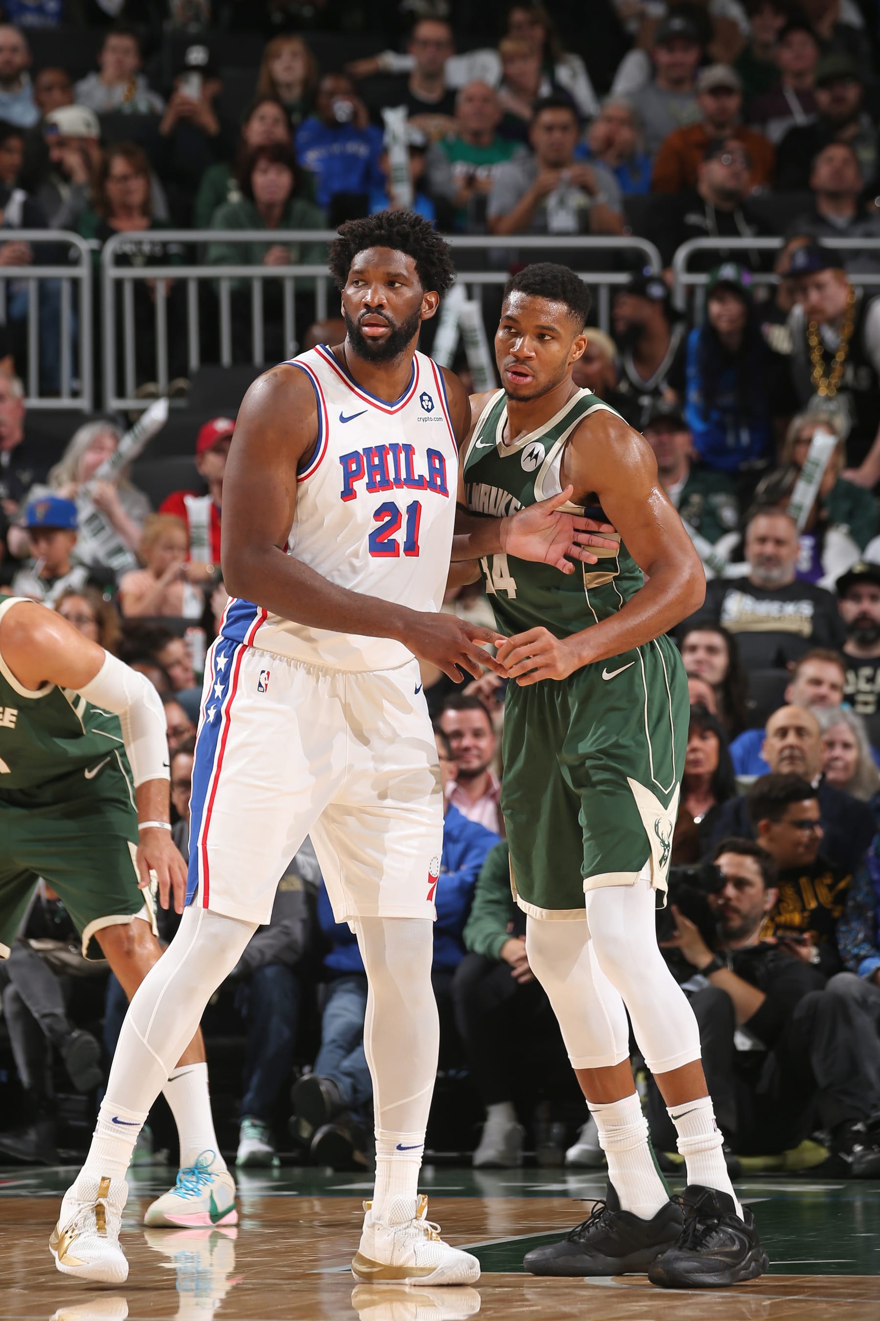 MILWAUKEE, WI - OCTOBER 26: Joel Embiid #21 of the Philadelphia 76ers and Giannis Antetokounmpo #34 of the Milwaukee Bucks look on during the game on October 26, 2023 at the Fiserv Forum Center in Milwaukee, Wisconsin. NOTE TO USER: User expressly acknowledges and agrees that, by downloading and or using this Photograph, user is consenting to the terms and conditions of the Getty Images License Agreement. Mandatory Copyright Notice: Copyright 2023 NBAE (Photo by Gary Dineen/NBAE via Getty Images).