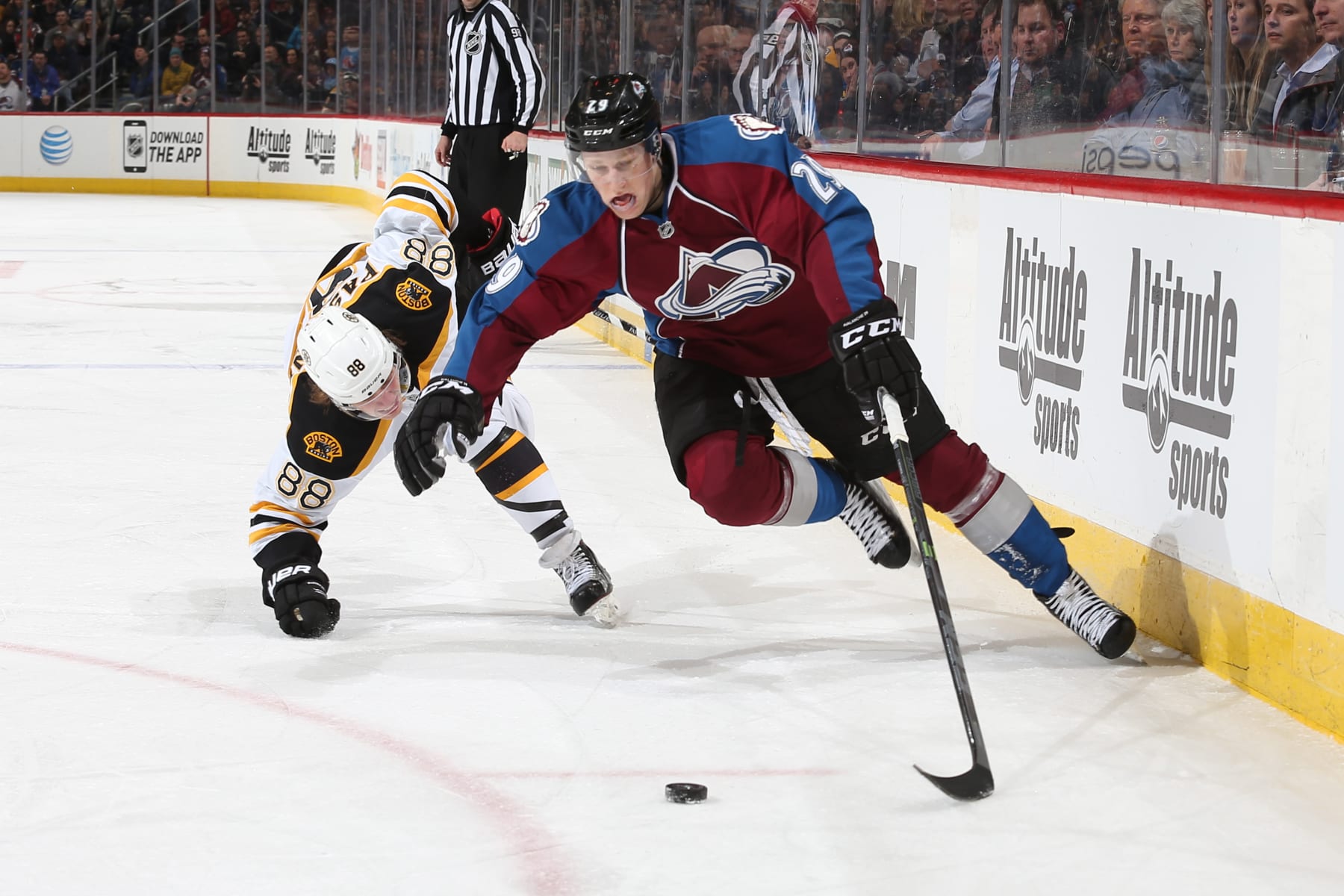 DENVER, CO - JANUARY 21: Nathan MacKinnon #29 of the Colorado Avalanche skates with the puck as he is challenged by David Pastrnak #88 of the Boston Bruins at the Pepsi Center on January 21, 2015 in Denver, Colorado.  (Photo by Michael Martin/NHLI via Getty Images)
