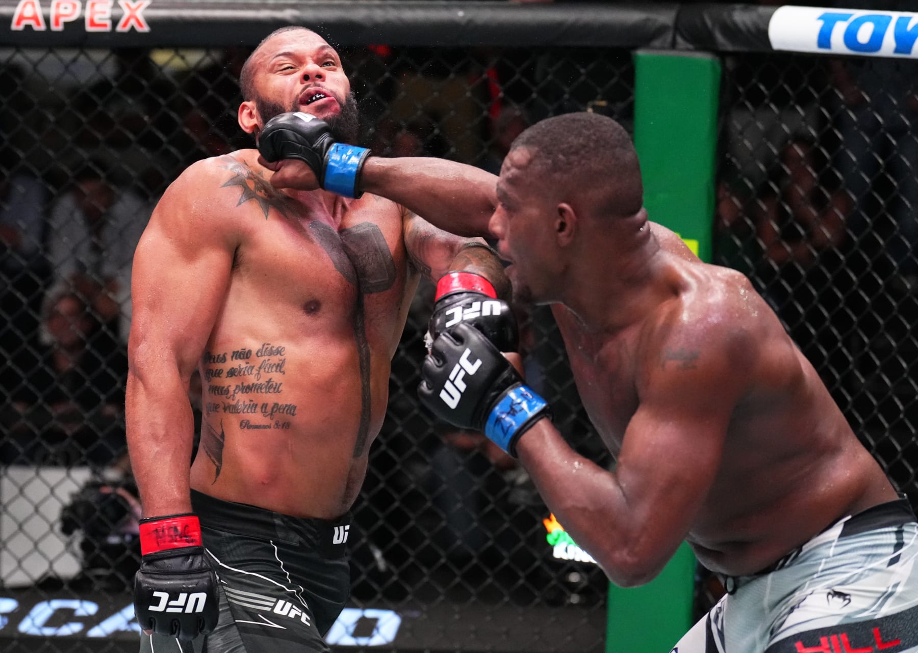 LAS VEGAS, NEVADA - AUGUST 06: (R-L) Jamahal Hill punches Thiago Santos of Brazil in a light heavyweight fight during the UFC Fight Night event at UFC APEX on August 06, 2022 in Las Vegas, Nevada. (Photo by Chris Unger/Zuffa LLC)